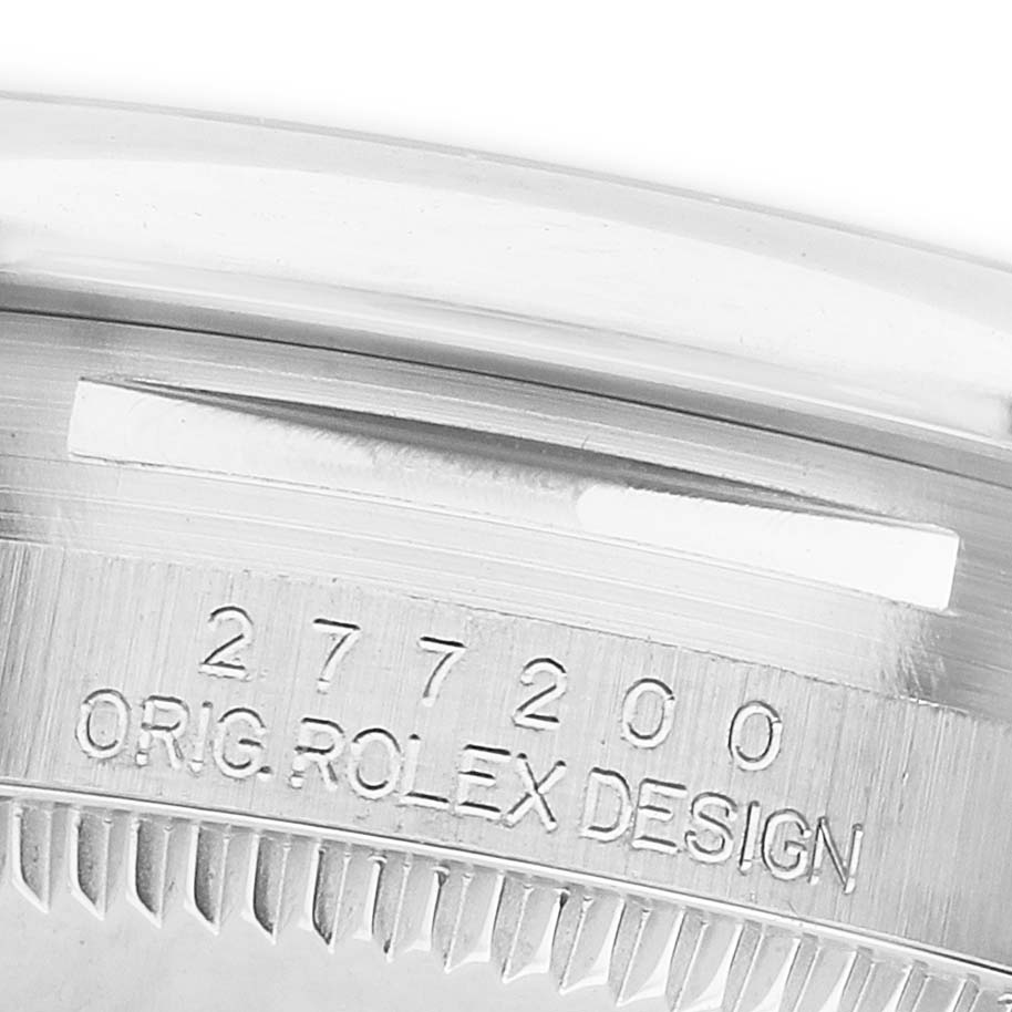 The image shows the engraved edge of the bezel and serial number for a Mid-Size Rolex model.