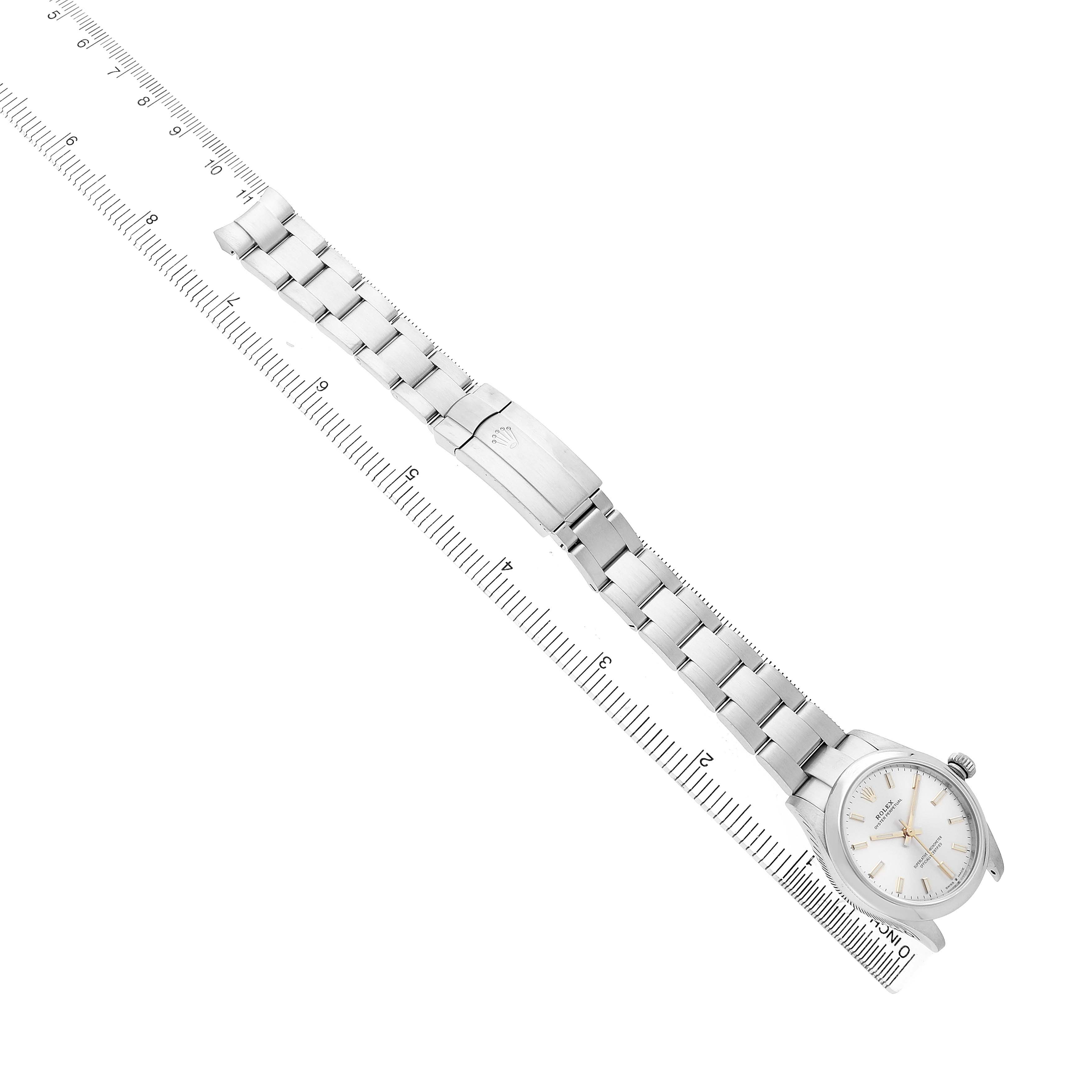 The Rolex Mid-Size 277200 Women's Stainless Steel Silver Dial watch is shown at a diagonal angle, highlighting the bracelet, clasp, and face.