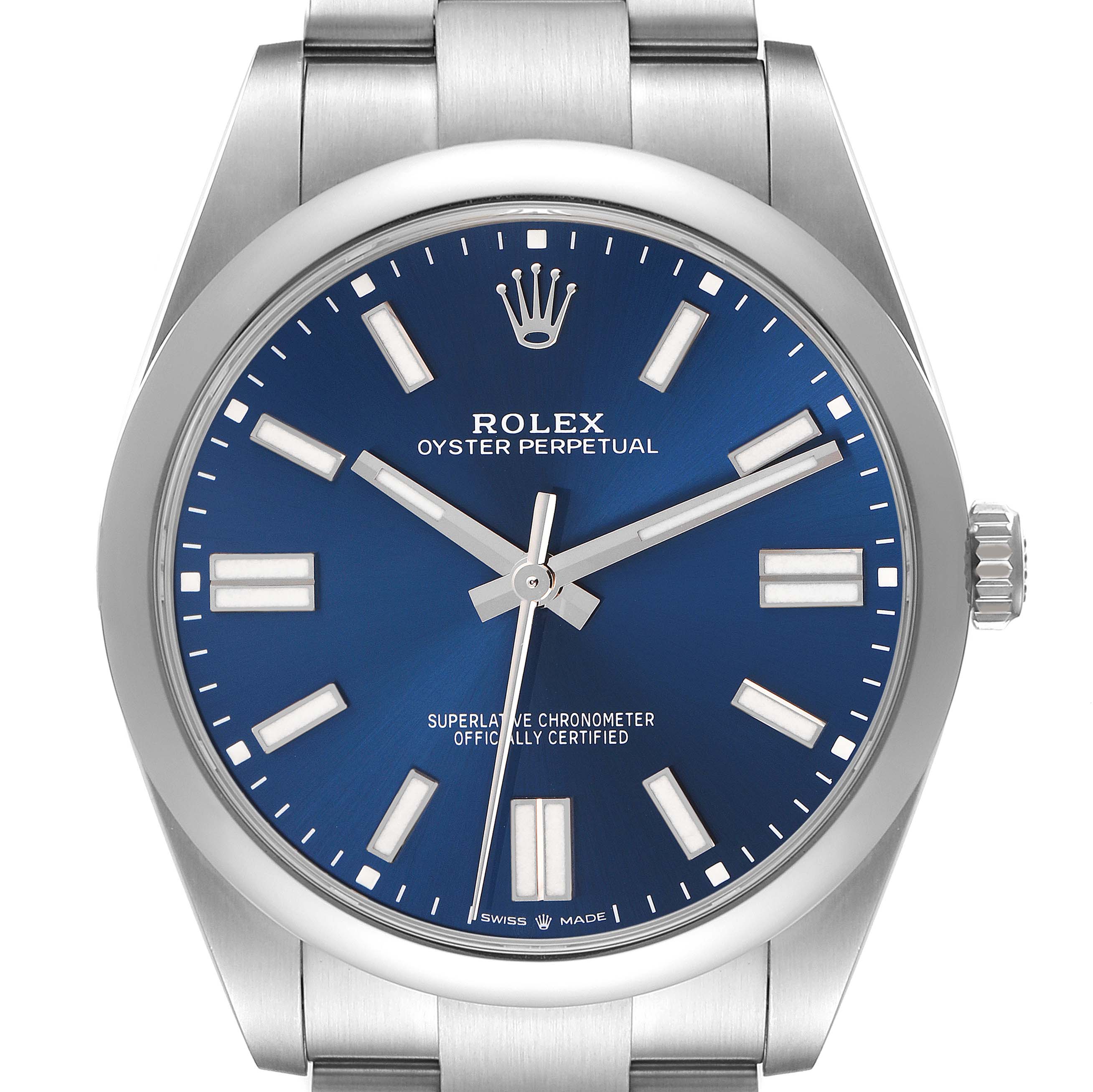 The image shows a Rolex Oyster Perpetual 124300 Men's Stainless Steel Blue Dial 124300 Men's Stainless Steel Blue Dial watch face from a front angle, displaying the blue dial, markers, and crown.