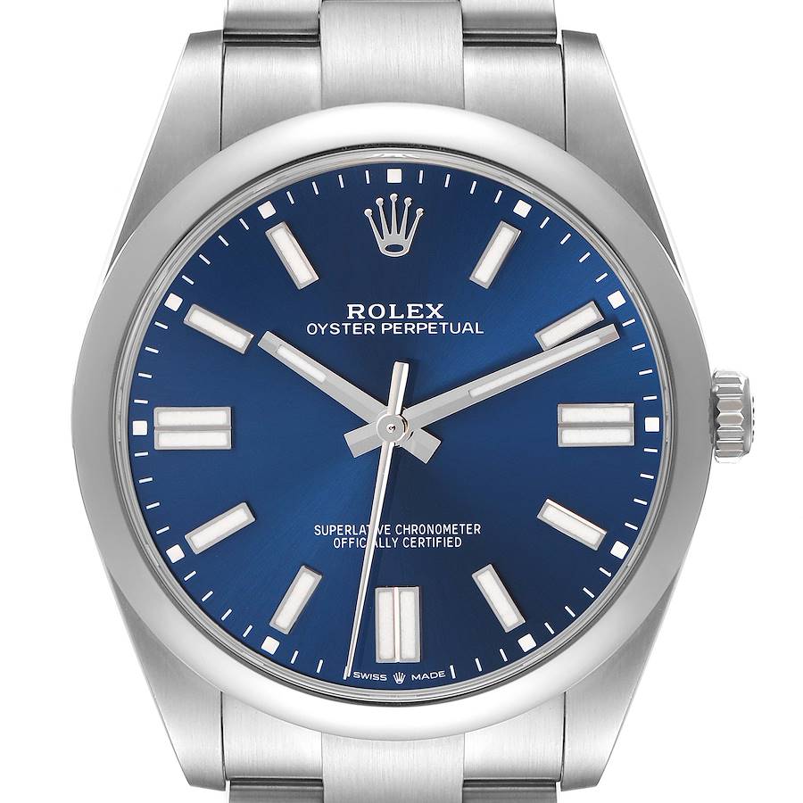The image shows a Rolex Oyster Perpetual watch face from a front angle, displaying the blue dial, markers, and crown.