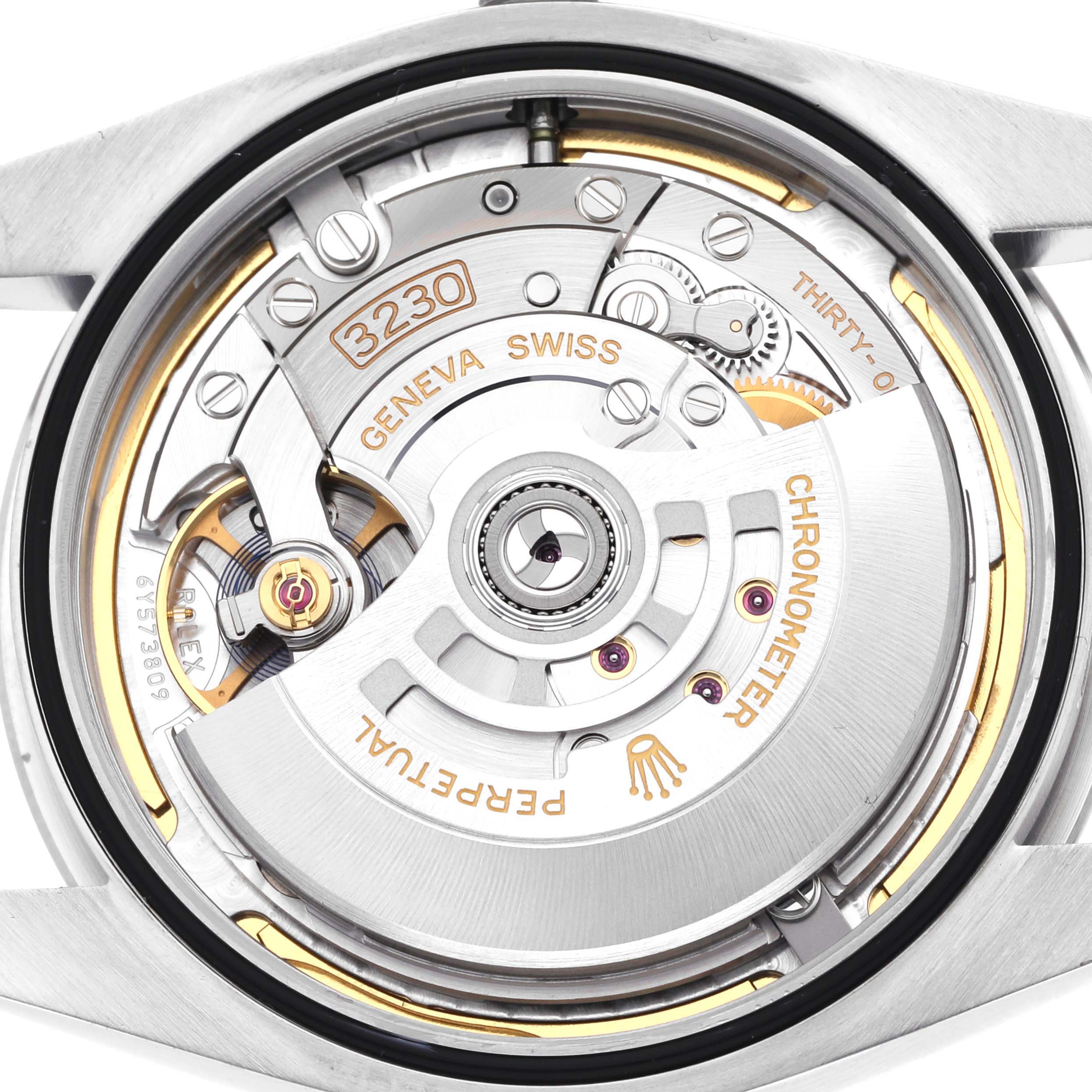 The image shows the movement of a Rolex Oyster Perpetual 124300 Men's Stainless Steel Blue Dial 124300 Men's Stainless Steel Blue Dial watch from a back angle, highlighting the rotor and gears.