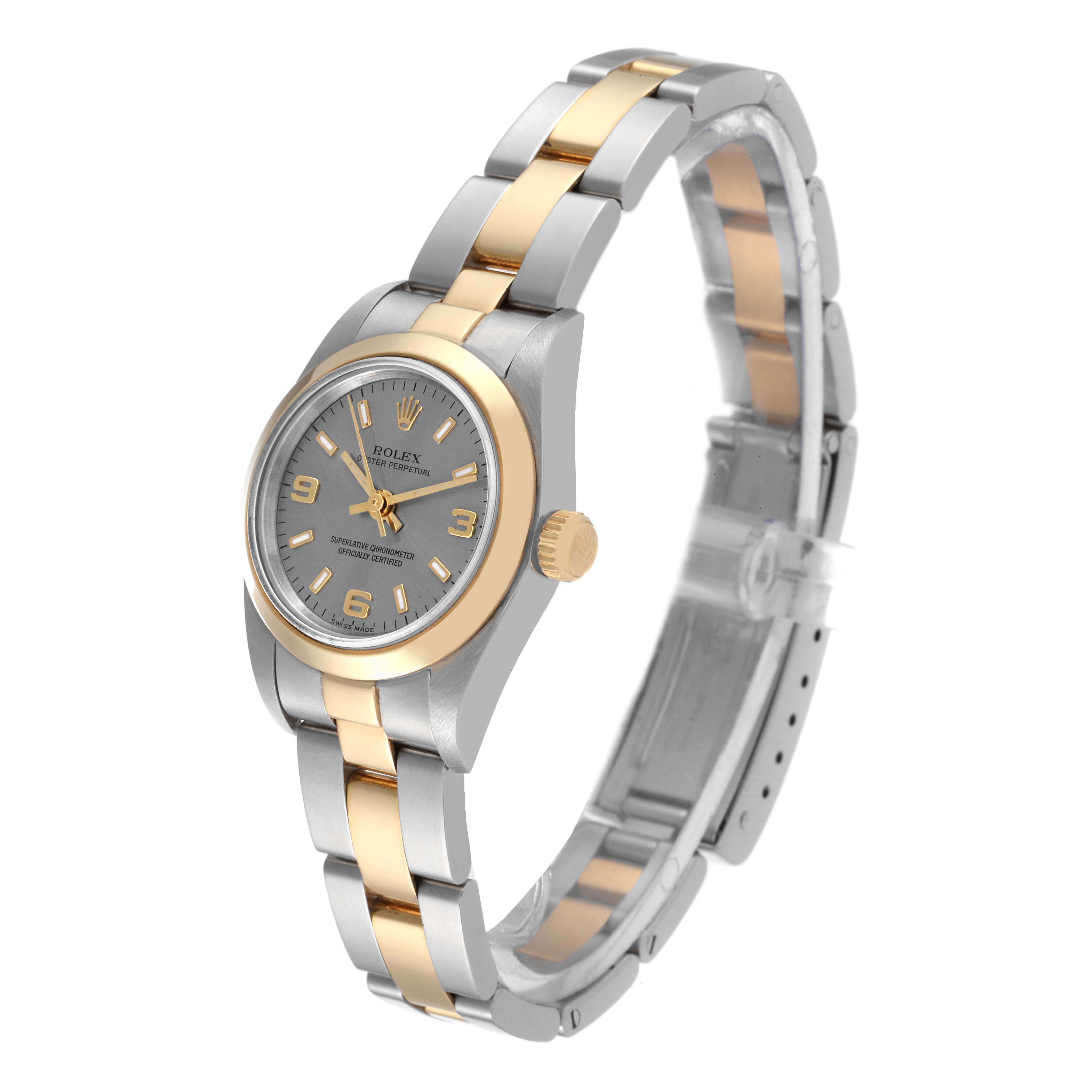 The Rolex Oyster Perpetual 76183 Women's Steel and Gold (two tone) Grey Dial 76183 Women's Steel and Gold (two tone) Grey Dial watch is shown at a slight angle, displaying its two-tone bracelet, face, and crown.