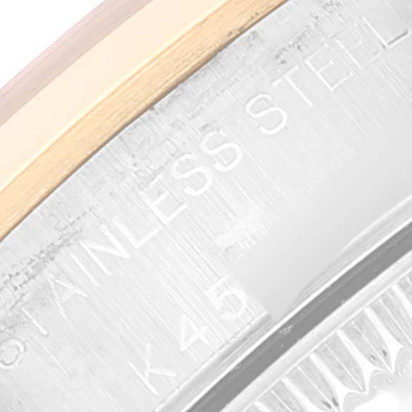 This is a macro shot of the side case of an Oyster Perpetual Rolex, showing the steel and possibly gold elements.