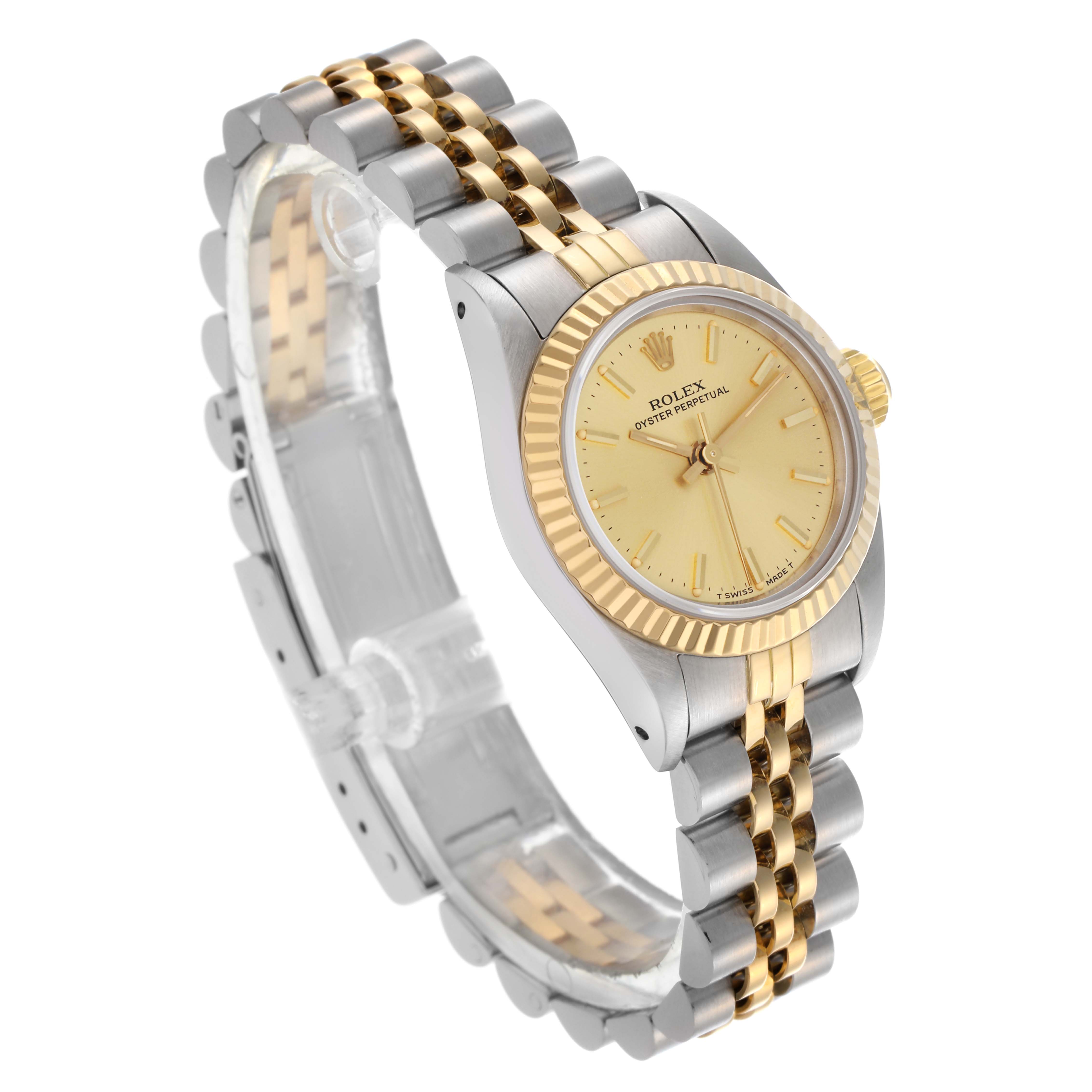 The Rolex Oyster Perpetual 67193 Women's Steel and Gold (two tone) Champagne Dial 67193 Women's Steel and Gold (two tone) Champagne Dial watch is shown at a three-quarter angle, highlighting its gold dial, fluted bezel, and two-tone bracelet.