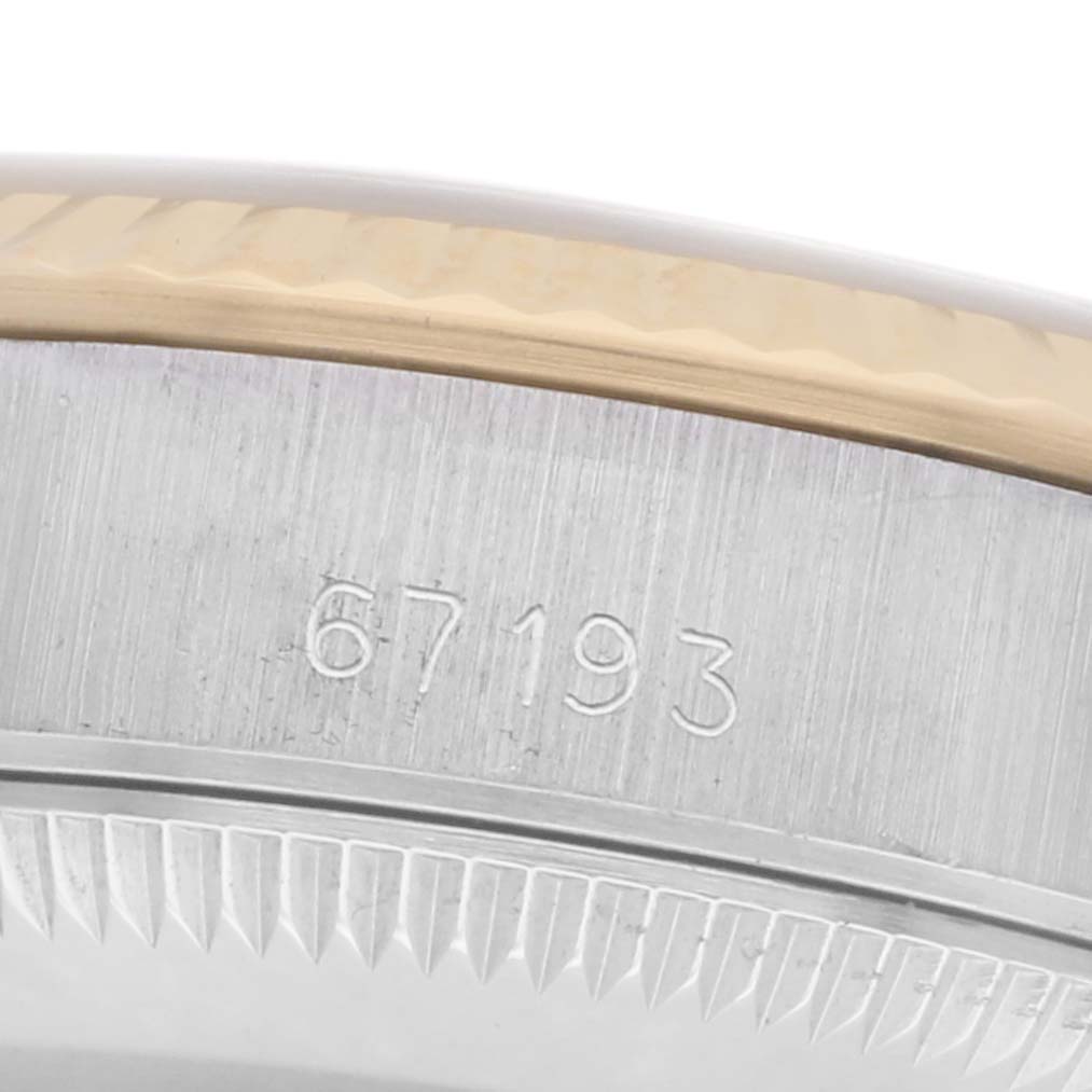 The image shows a close-up of the side engraving and bezel edge of a Rolex Oyster Perpetual 67193 Women's Steel and Gold (two tone) Champagne Dial 67193 Women's Steel and Gold (two tone) Champagne Dial watch.