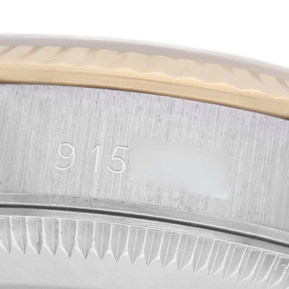 The image shows a close-up angle of the edge of a Rolex Oyster Perpetual 67193 Women's Steel and Gold (two tone) Champagne Dial 67193 Women's Steel and Gold (two tone) Champagne Dial bezel with engraved numbers.
