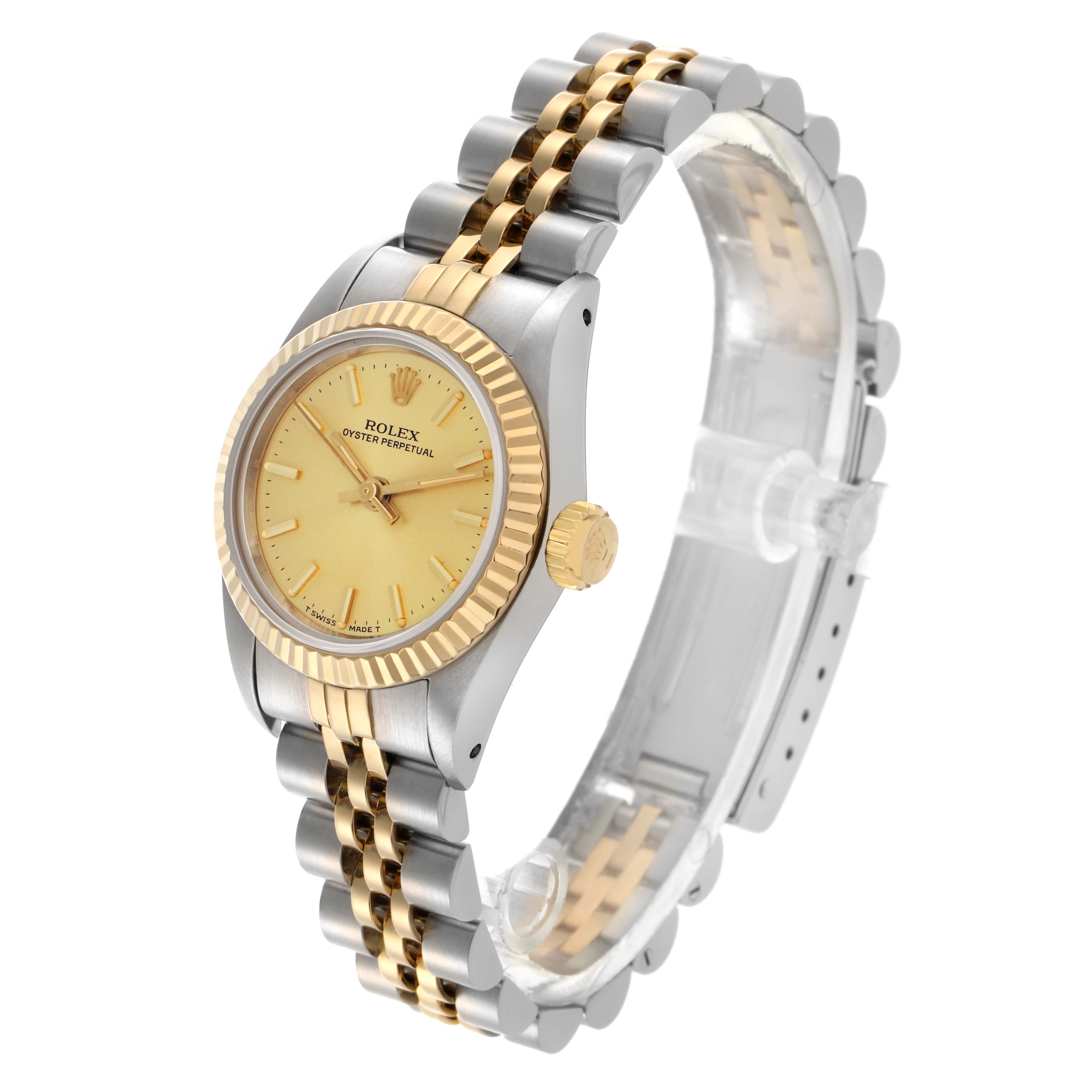 The Rolex Oyster Perpetual 67193 Women's Steel and Gold (two tone) Champagne Dial 67193 Women's Steel and Gold (two tone) Champagne Dial watch is displayed at an angled side view, showing its gold and silver mixed bracelet, bezel, and crown.