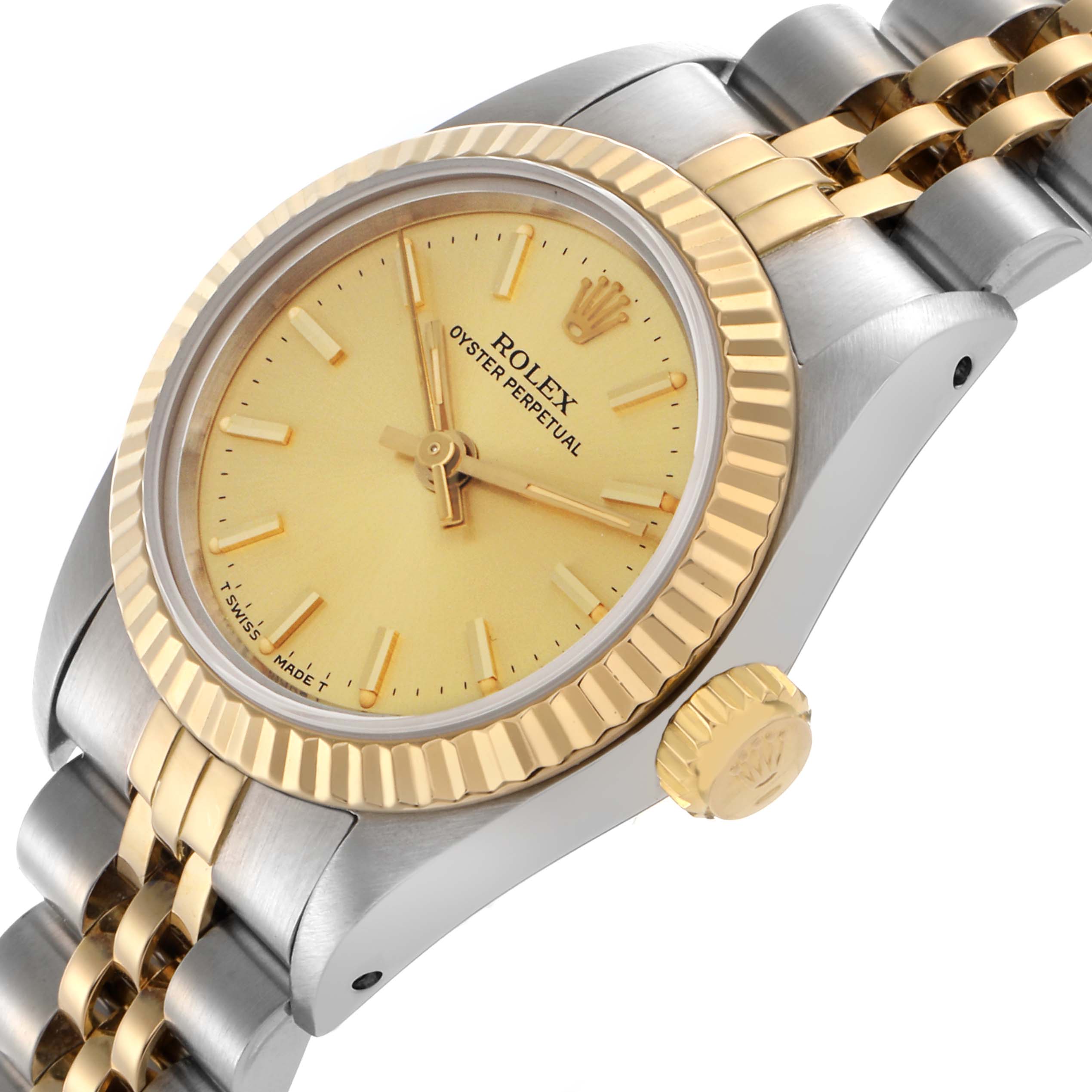 The image shows a side-angled view of a Rolex Oyster Perpetual 67193 Women's Steel and Gold (two tone) Champagne Dial 67193 Women's Steel and Gold (two tone) Champagne Dial, highlighting the yellow gold bezel, crown, and two-tone bracelet.