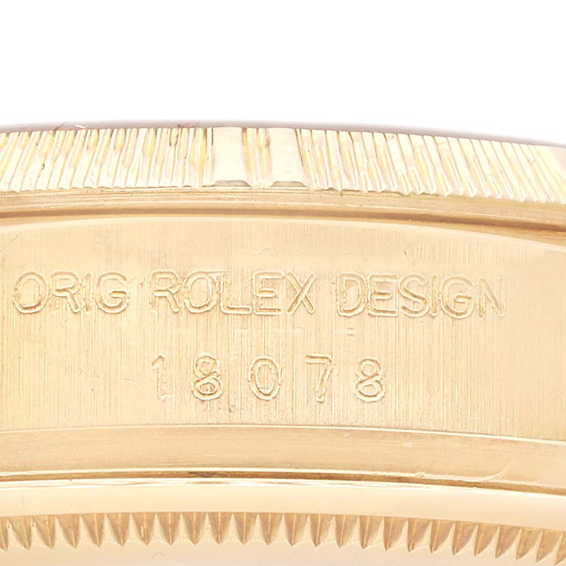 The image shows a close-up of the side and bezel edge of a Rolex President 18078 Men
s Yellow Gold Champagne Dial 18078 Men
s Yellow Gold Champagne Dial model, with the engraved serial number visible.