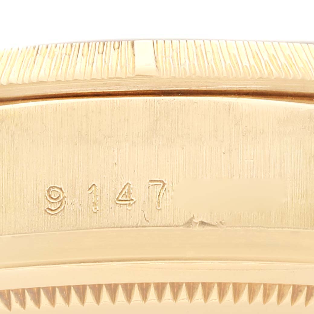 The image shows a close-up of the side of a Rolex President 18078 Men
s Yellow Gold Champagne Dial 18078 Men
s Yellow Gold Champagne Dial watch, highlighting the serial number on the case.