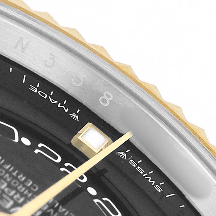 The image shows a close-up of the Rolex Sky-Dweller 336933 Men's Steel and Gold (two tone) Black Dial, focusing on the bezel, partial dial, and markers.