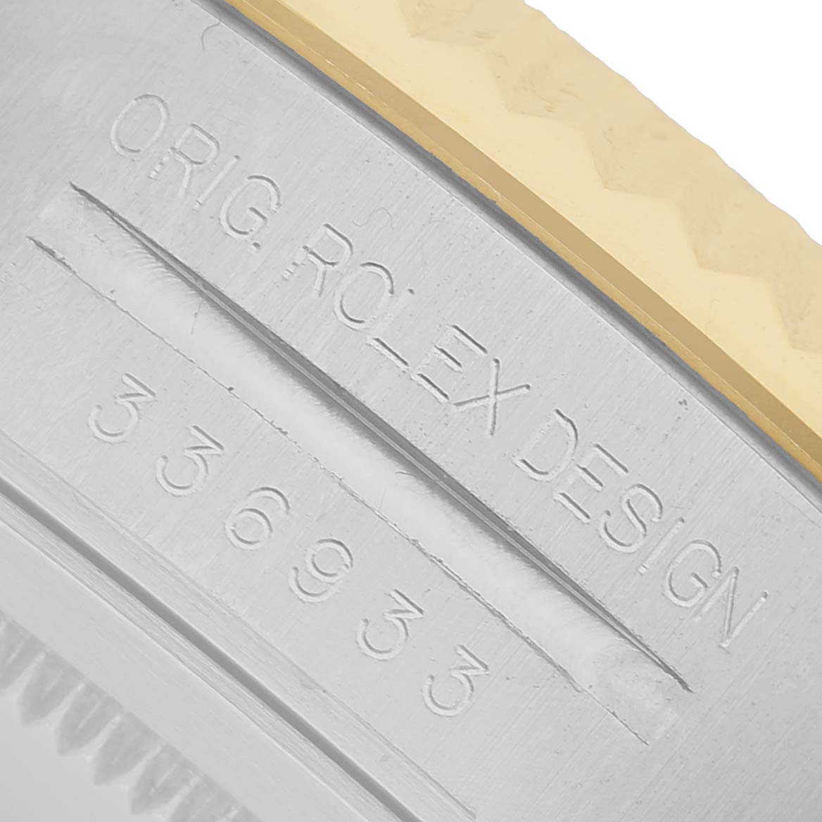 The image shows a close-up of the engraved case side of a Rolex Sky-Dweller 336933 Men's Steel and Gold (two tone) Black Dial, highlighting its model number and design inscription.