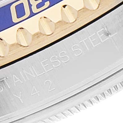 This close-up shows the side view of the bezel and part of the case of a Rolex Submariner 16613 Men
s Steel and Gold (two tone) Blue Dial 16613 Men
s Steel and Gold (two tone) Blue Dial watch, highlighting the "STAINLESS STEEL" engraving.