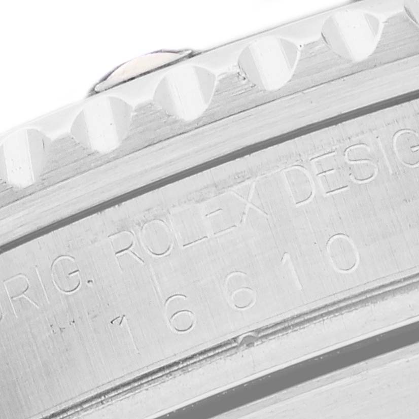 The image shows a close-up of the serial number engraving on the side of a Rolex Submariner 16610 Men
s Stainless Steel Black Dial 16610 Men
s Stainless Steel Black Dial model.