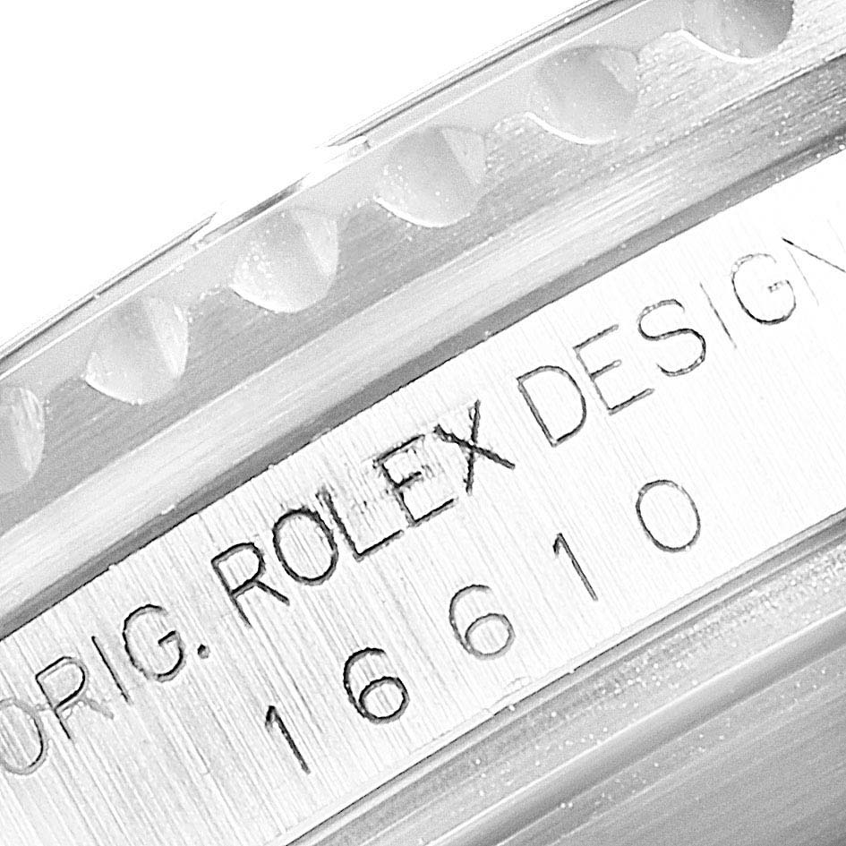The image shows a close-up of the bezel and engraved design information of the Rolex Submariner 16610 Men
s Stainless Steel Black Dial 16610 Men
s Stainless Steel Black Dial model 16610.