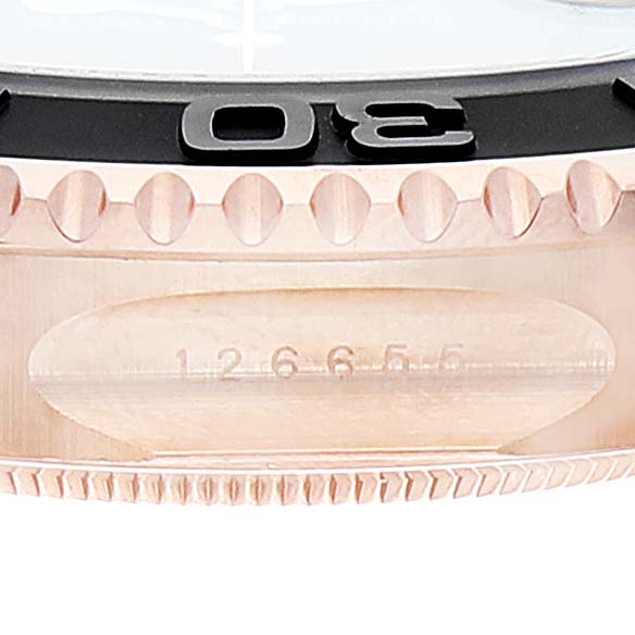 This image shows a close-up of the bezel and part of the case of a Rolex Yacht-Master 126655 Men's Rose Gold Black Dial 126655 Men's Rose Gold Black Dial watch.