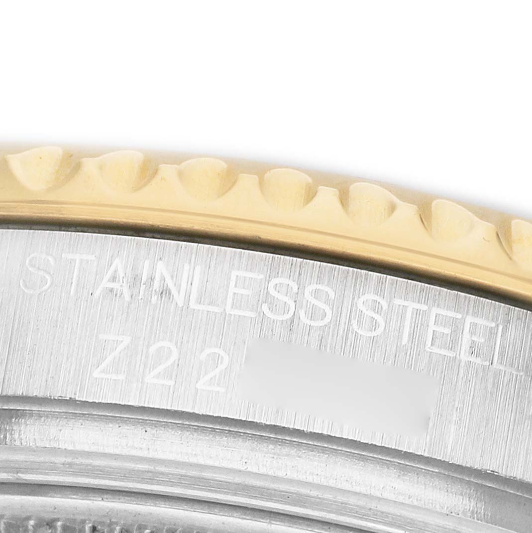 The image shows a close-up of the Rolex Yacht-Master 168623 Men's Steel and Gold (two tone) Grey Dial's bezel edge and engraved case, highlighting the detailing and material.