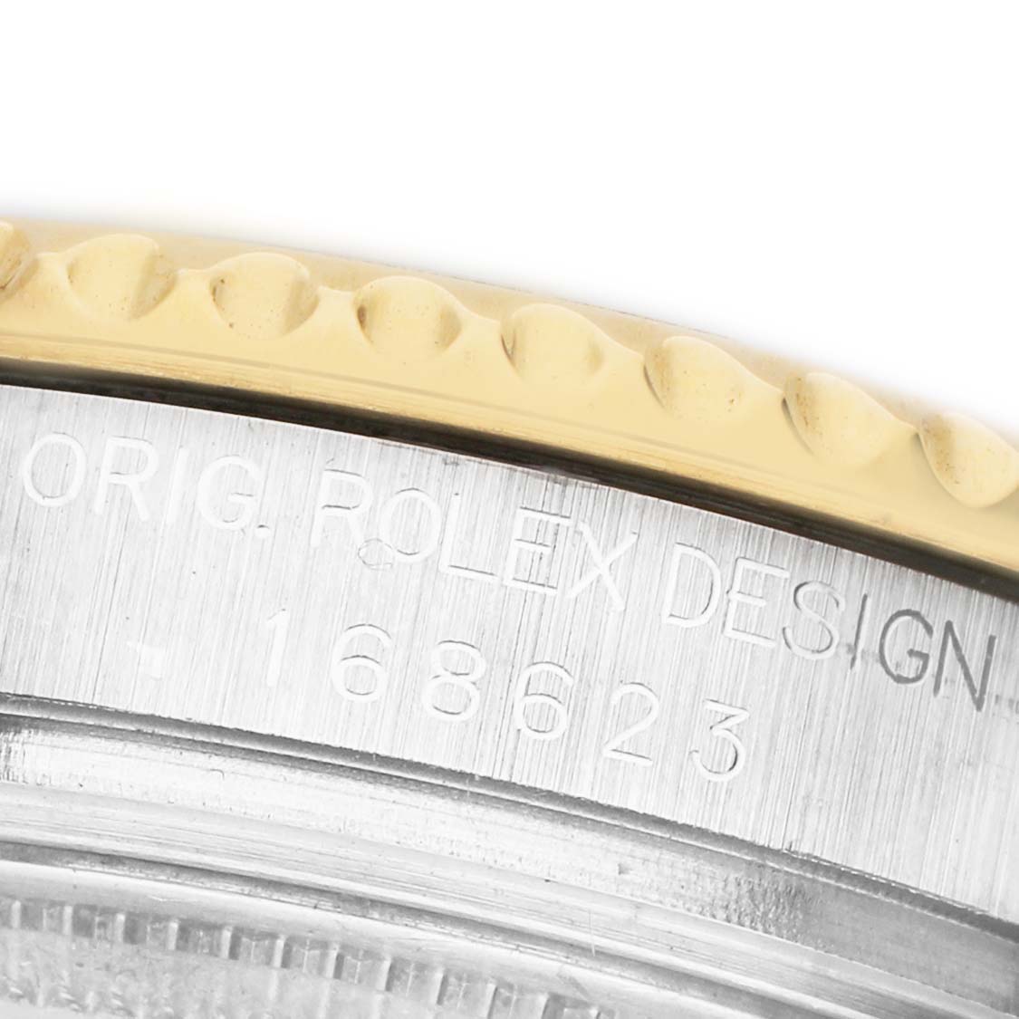 The image shows a close-up of the Rolex Yacht-Master 168623 Men's Steel and Gold (two tone) Grey Dial's case with branded engraving and the edge of the bezel.