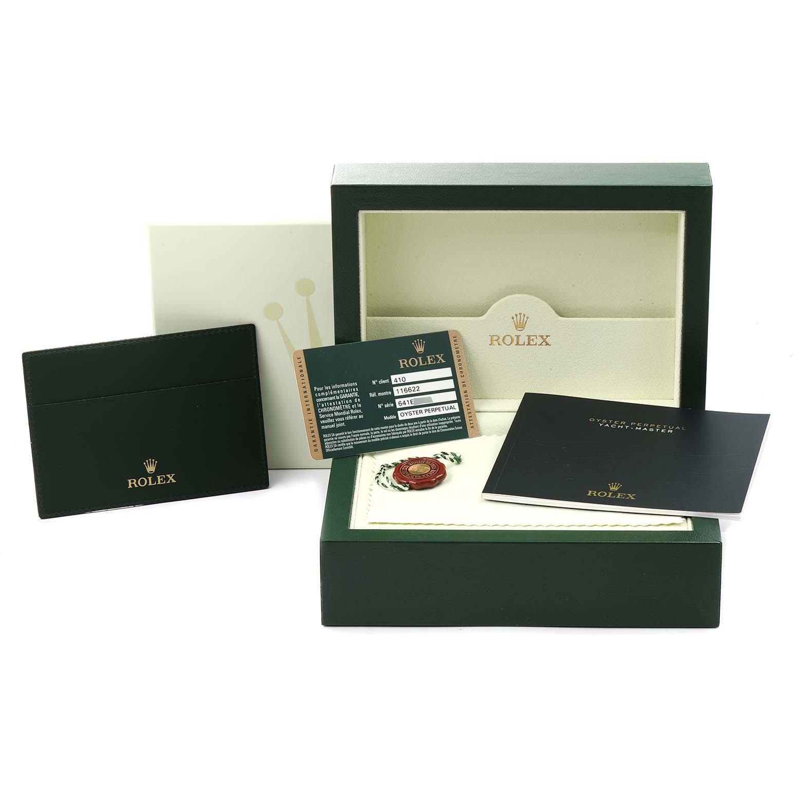 The image shows the packaging and accessories of a Rolex Yacht-Master 116622 Men
s Stainless Steel Grey Dial 116622 Men
s Stainless Steel Grey Dial, including the box, manuals, warranty card, and tags.