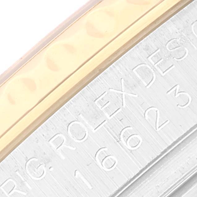 This close-up shows the engraved side of the case and part of the bezel of a Rolex Yacht-Master 16623 Men's Steel and Gold (two tone) Champagne Dial 16623 Men's Steel and Gold (two tone) Champagne Dial watch.