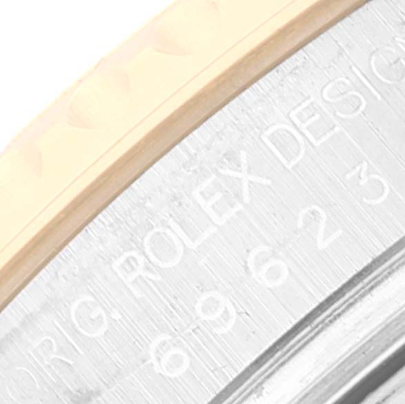 This close-up image shows part of the bezel and the engraved text on the case of a Rolex Yacht-Master 69623 Women's Steel and Gold (two tone) Grey Dial 69623 Women's Steel and Gold (two tone) Grey Dial watch.