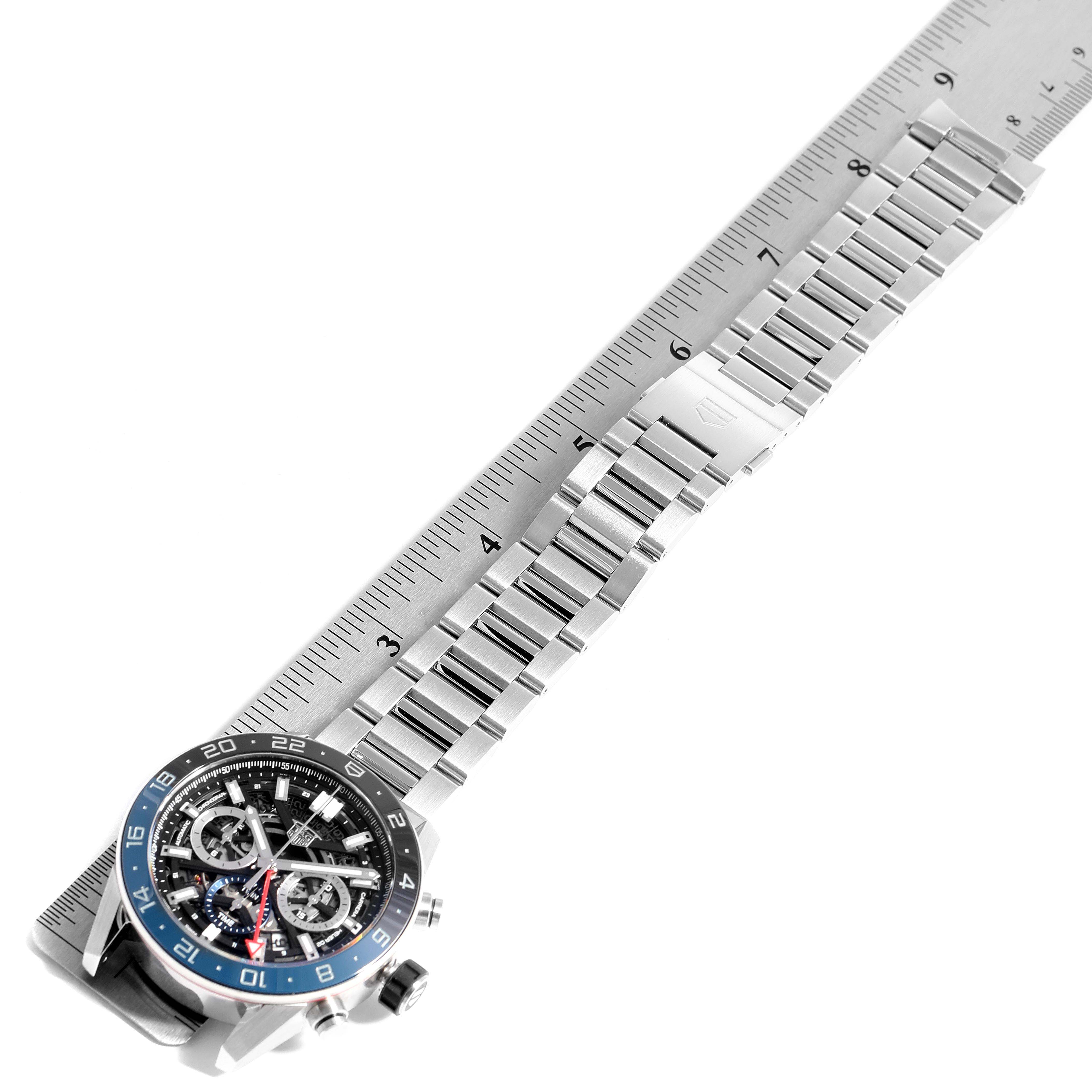 The image shows a Tag Heuer Carrera CBG2A1Z.BA0658 Men's Stainless Steel Transparent Dial CBG2A1Z.BA0658 Men's Stainless Steel Transparent Dial watch at a top-down angle, displaying the face and metal bracelet alongside a ruler.