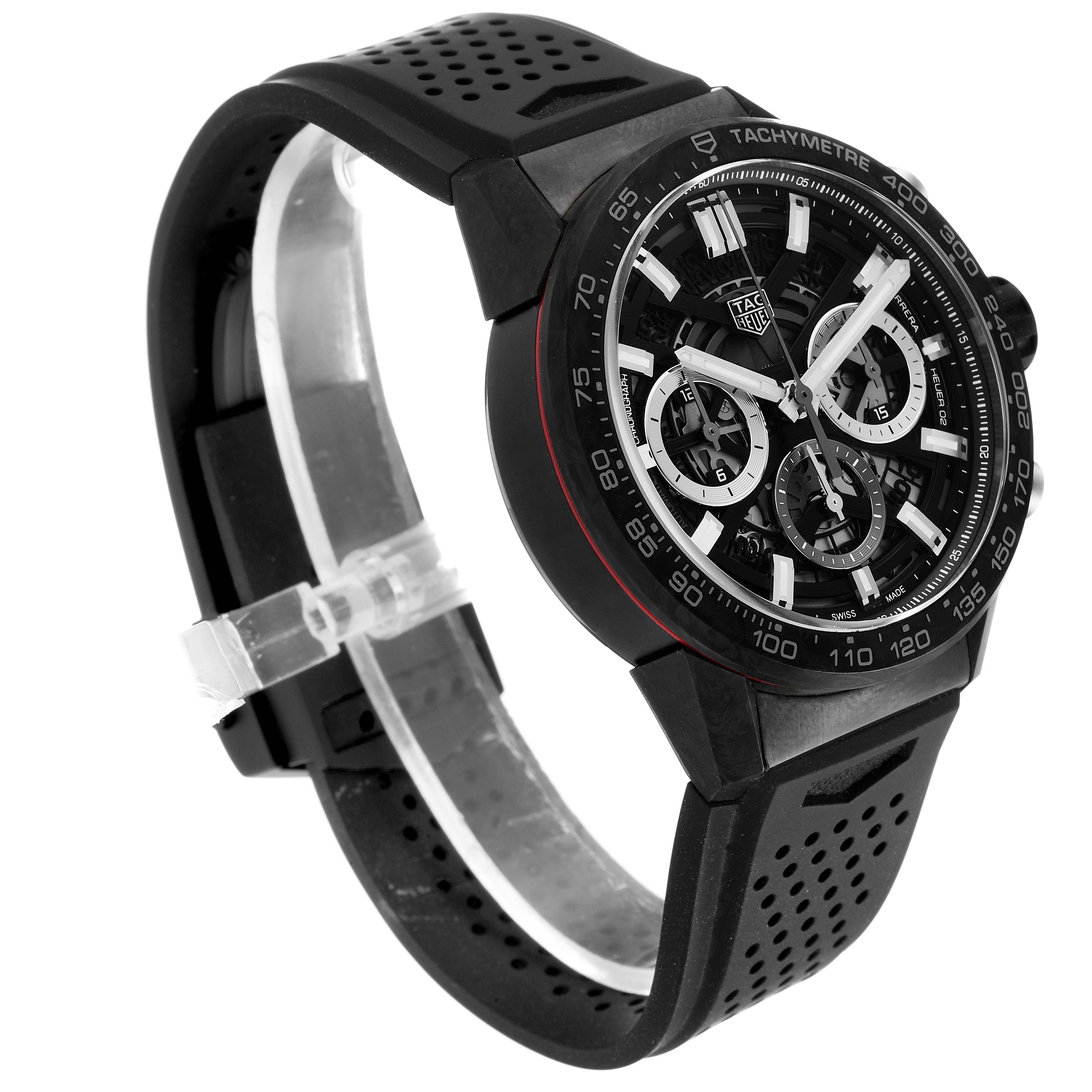 The image shows a Tag Heuer Carrera CBG2016.FT6143 Men's Stainless Steel Black Dial CBG2016.FT6143 Men's Stainless Steel Black Dial watch from an angled side view, highlighting its black case, tachymeter bezel, and perforated strap.