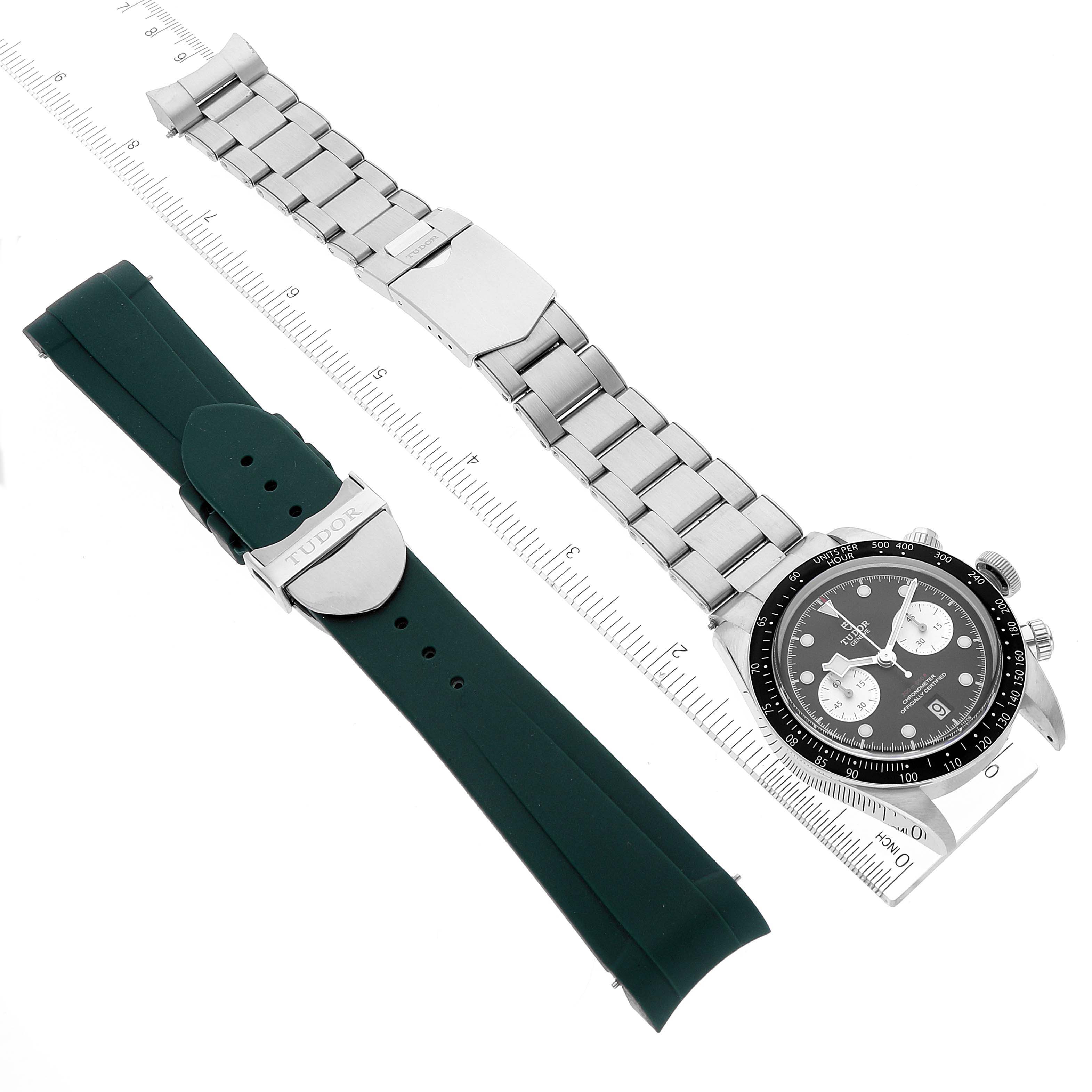 The image shows the Tudor Heritage Black Bay 79360N Men
s Stainless Steel Black Dial 79360N Men
s Stainless Steel Black Dial watch with a metal bracelet and an additional green rubber strap, laid flat with rulers for scale.