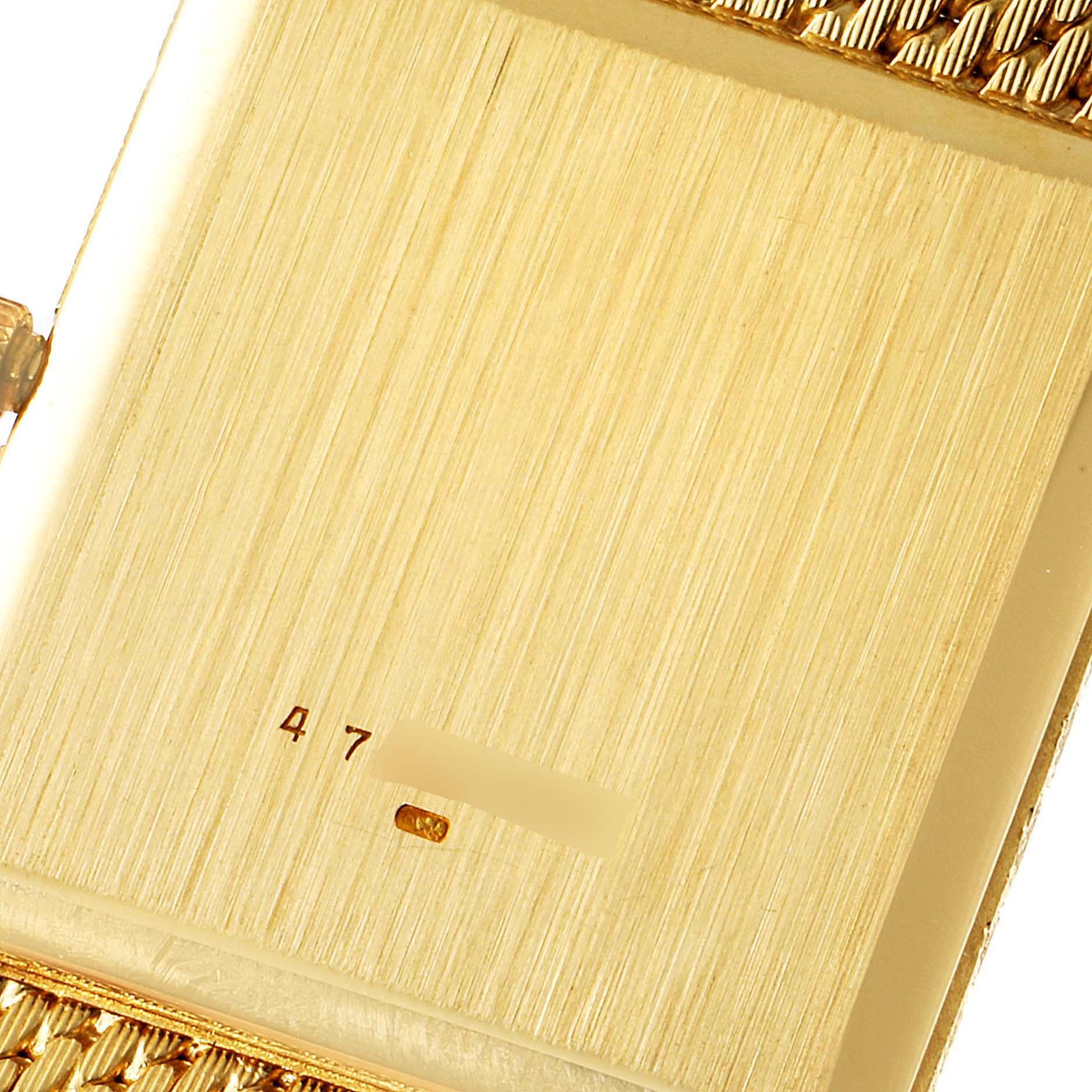 This close-up image shows the back case and part of the bracelet of a Vintage Vacheron Constantin watch.