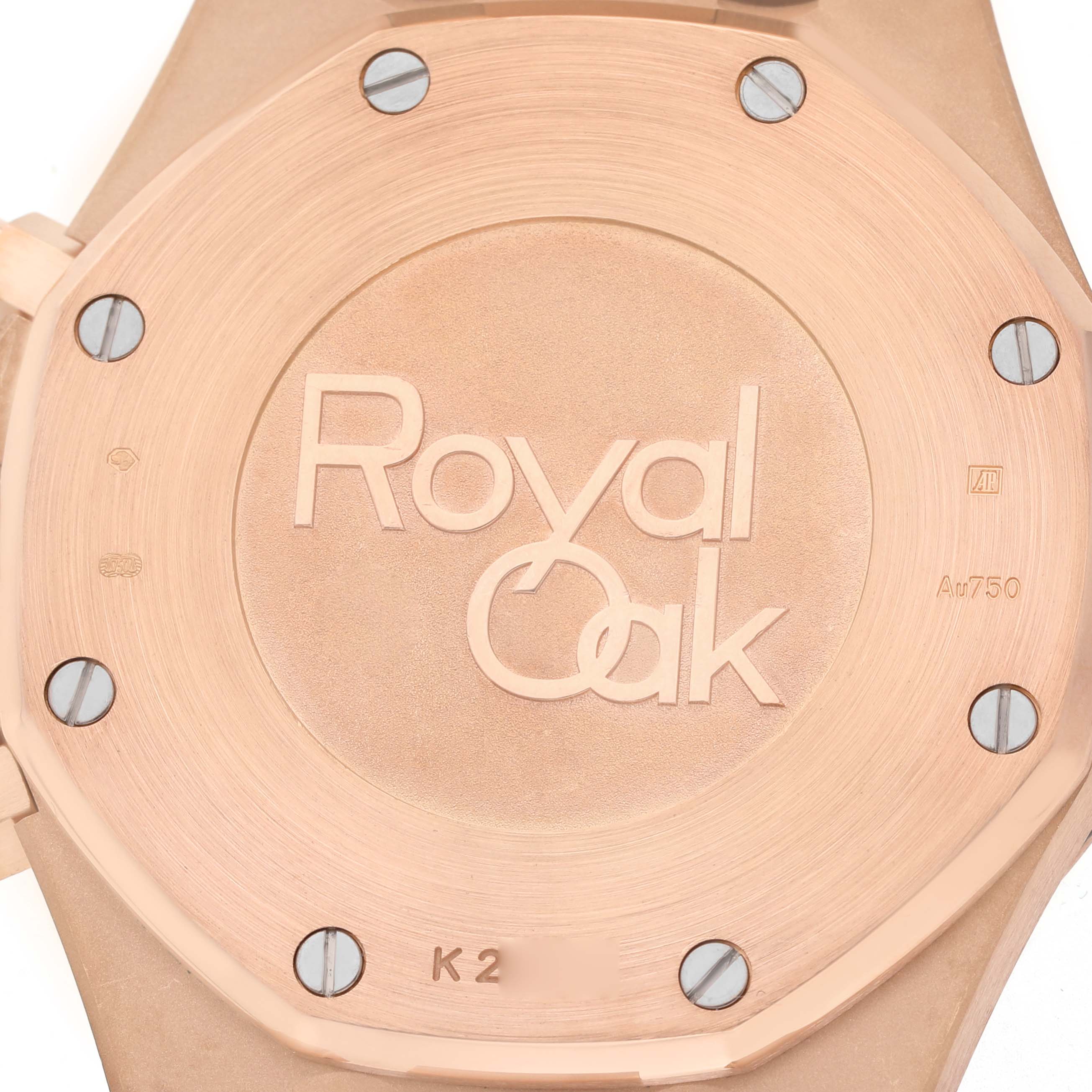 The image shows the back case of an Audemars Piguet Royal Oak 26331OR Men's Rose Gold Brown Dial watch, featuring the engraved logo and visible screws.