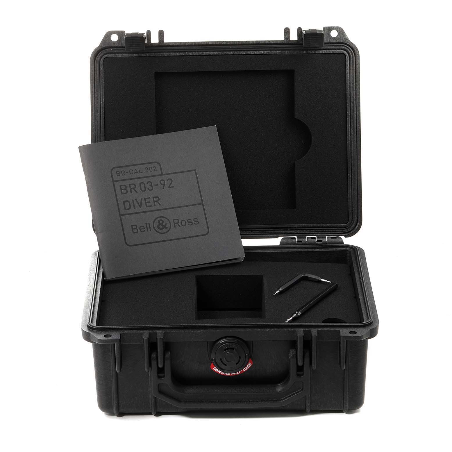 The image shows the opened case of a Bell & Ross Diver model watch with its instruction manual and tools.