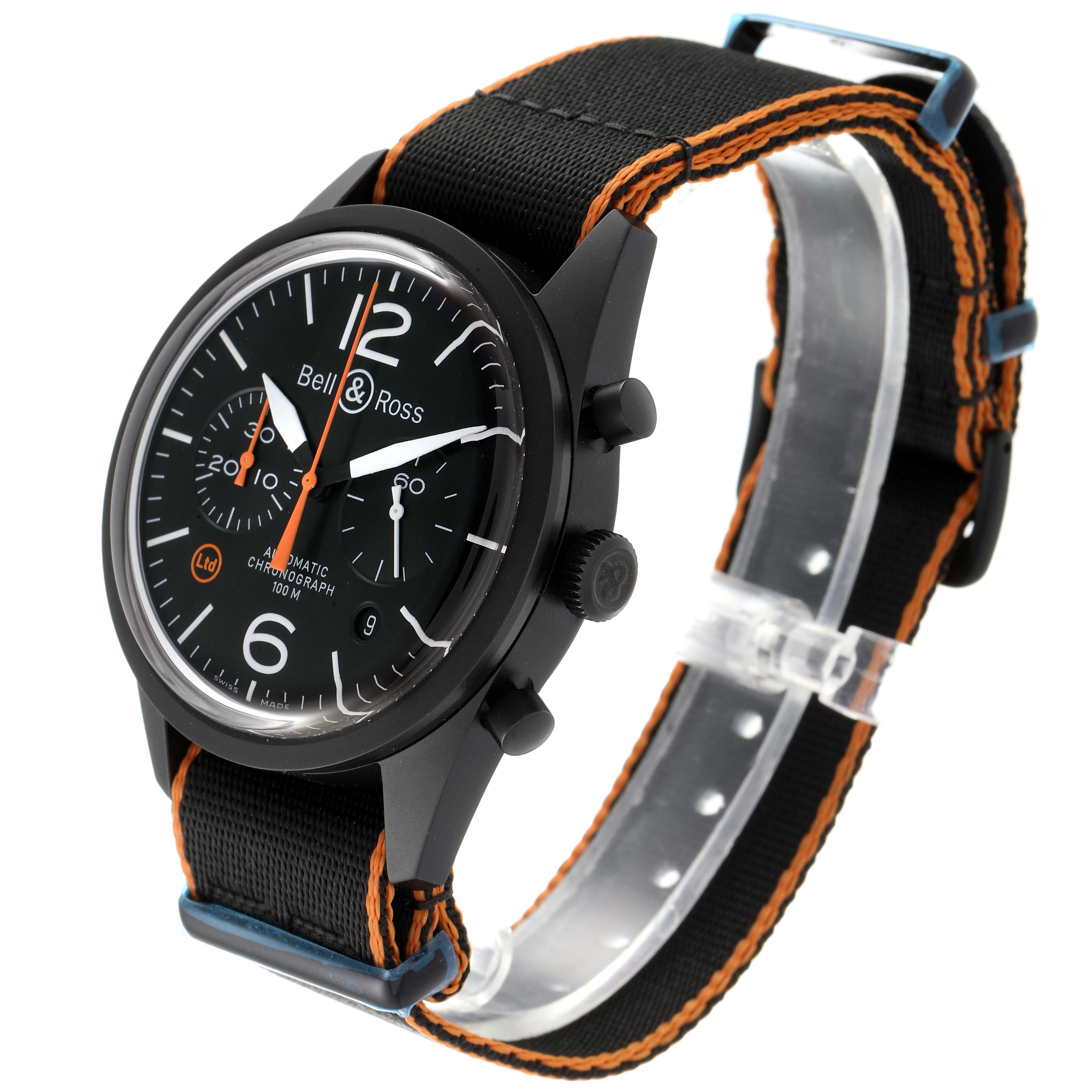 The image shows a Bell & Ross Vintage model watch at a three-quarter angle with a black strap and black dial with orange accents.