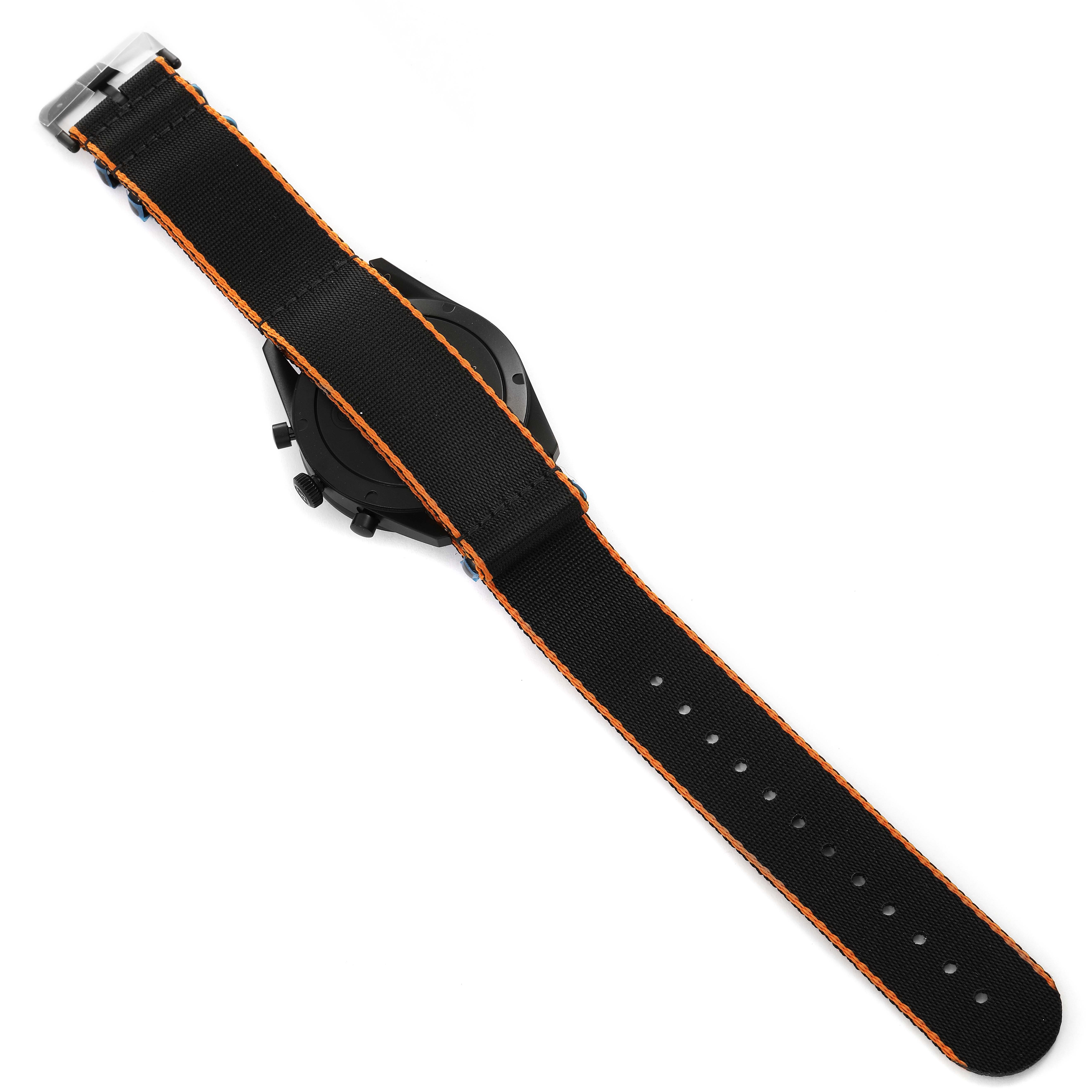 The image shows the back and partially the side of a Bell & Ross Vintage model watch with an attached black strap featuring orange stitching.