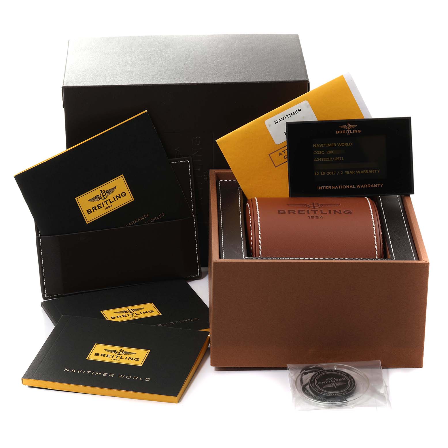 The image shows the packaging and accessories for a Breitling Navitimer A24322 Men's Stainless Steel Silver Dial A24322 Men's Stainless Steel Silver Dial watch, including the box, warranty card, booklet, and case.