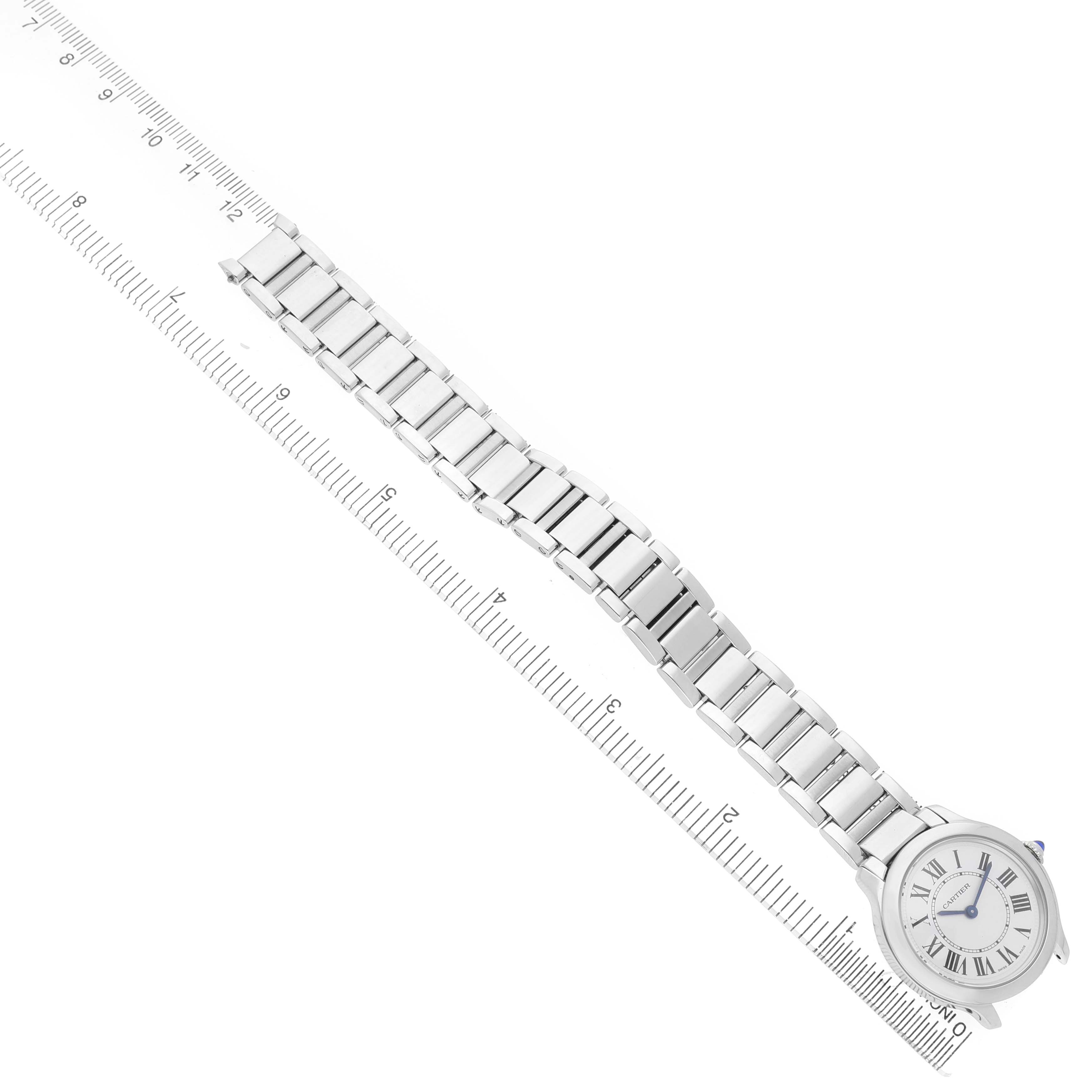 The Cartier Ronde WSRN0033 Women's Stainless Steel Silver Dial watch is shown diagonally from above, displaying the bracelet and face alongside a ruler.