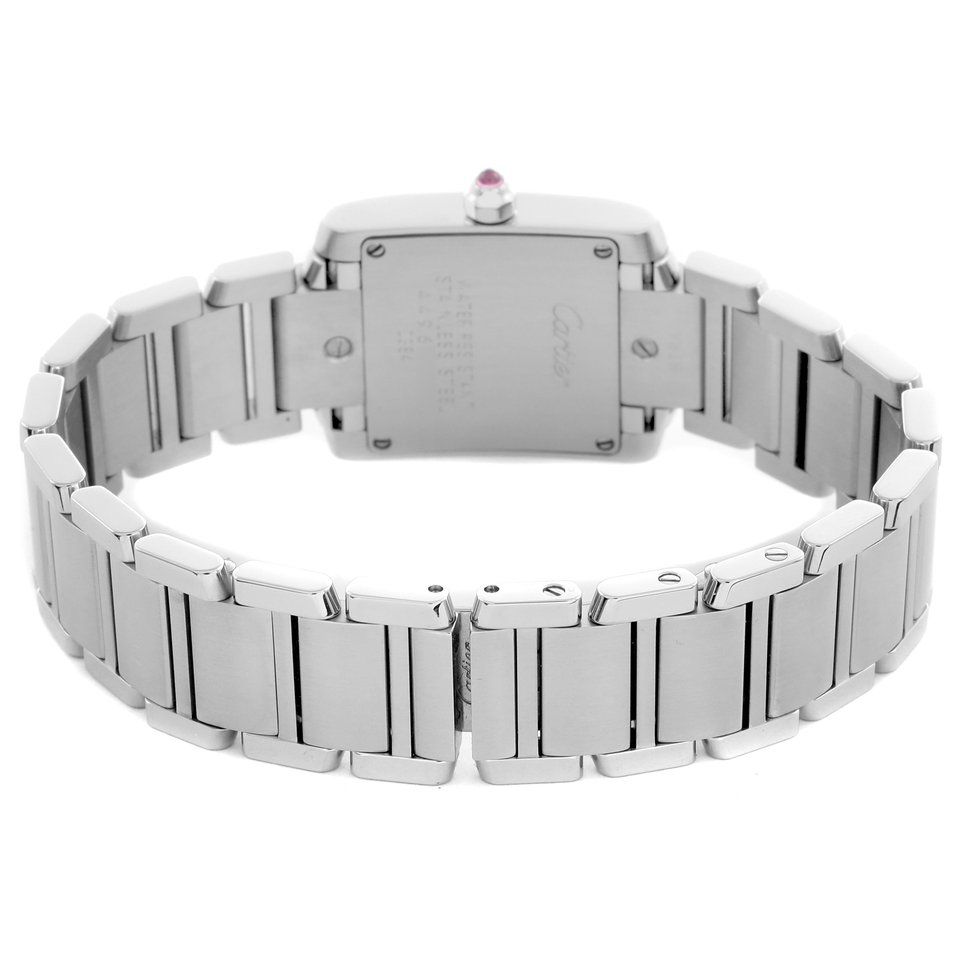 The Cartier Tank Française is shown from the back, highlighting the stainless steel bracelet and case back.