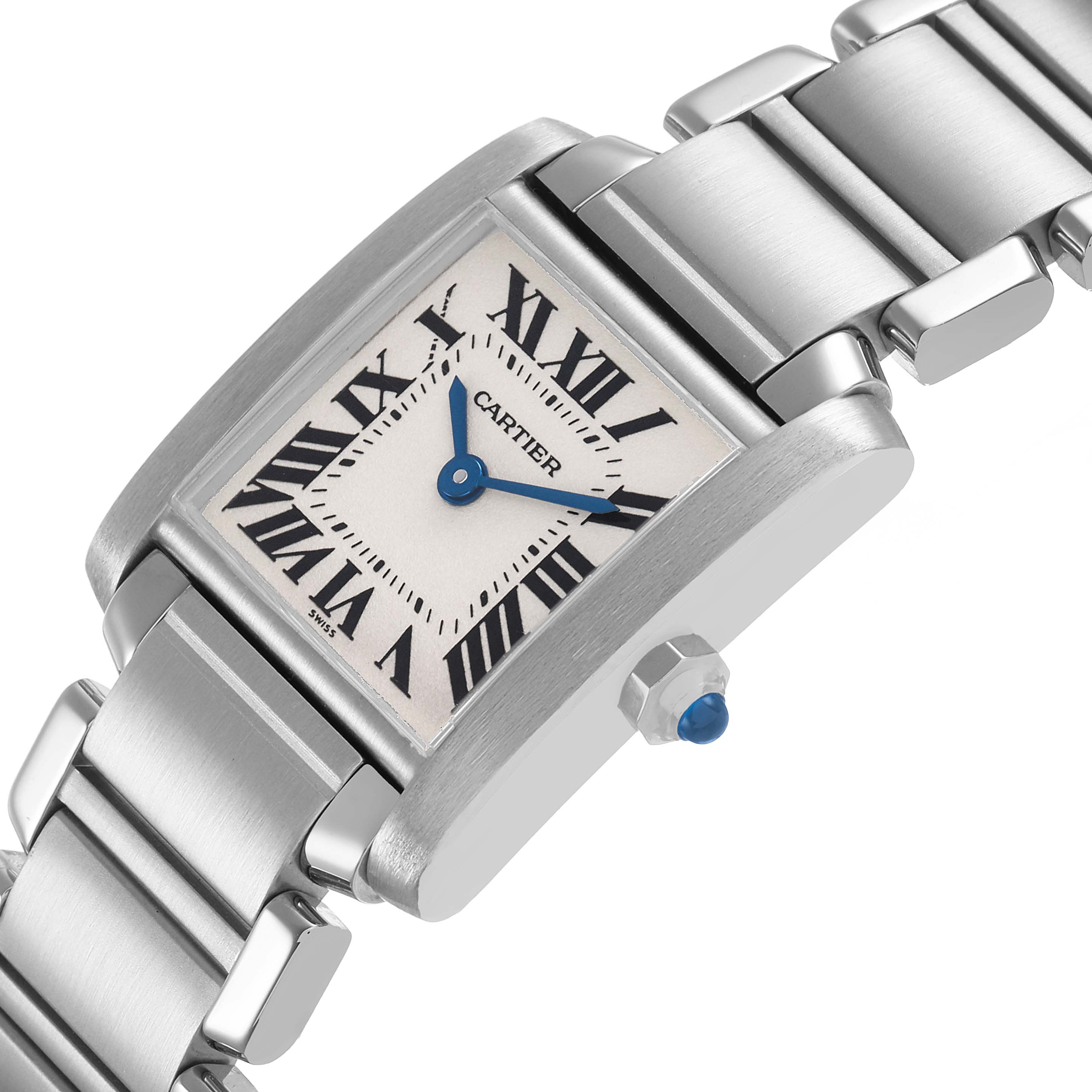 The Cartier Tank Française watch is shown at an angle highlighting its face, Roman numerals, blue hands, and polished metal bracelet.