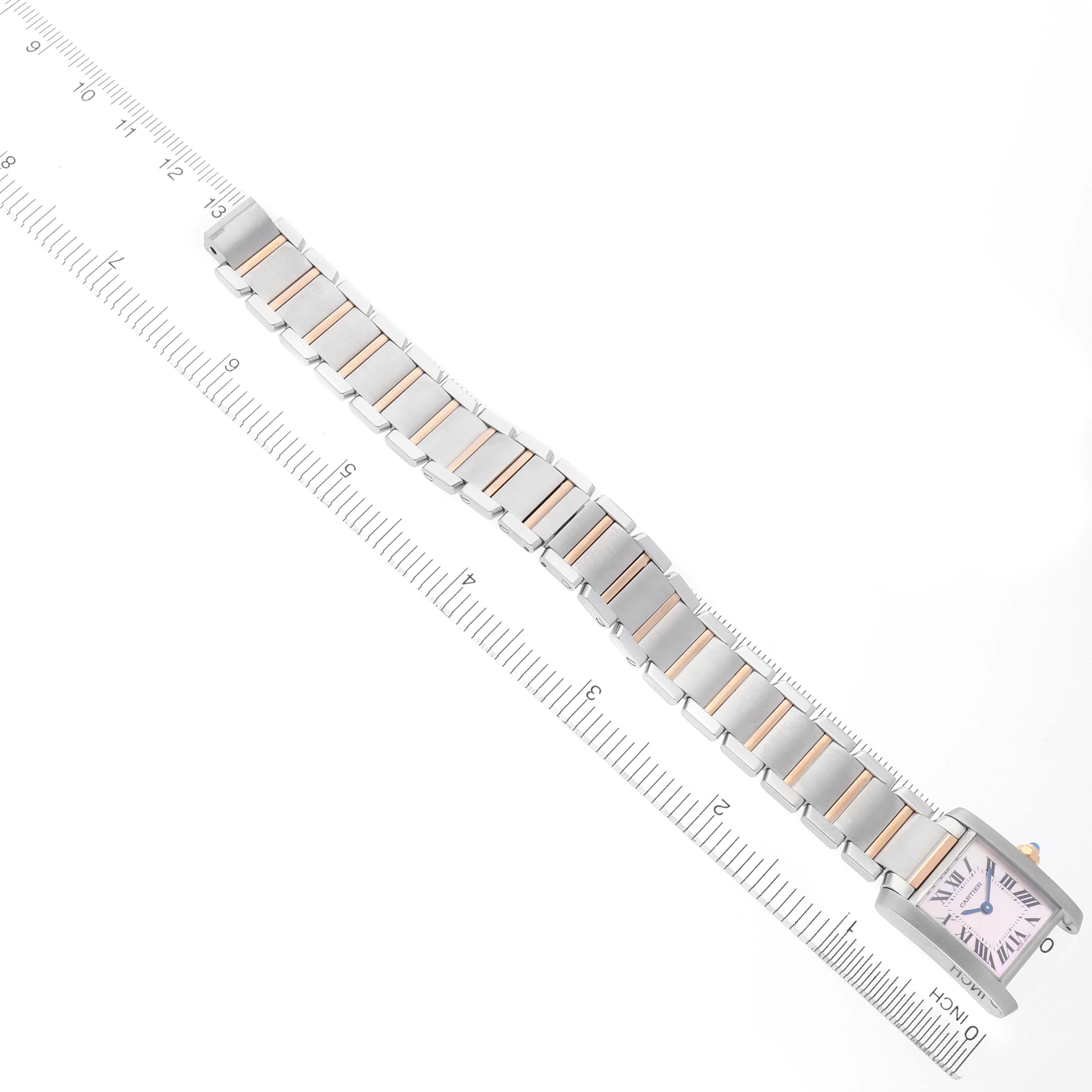 The image shows a Cartier Tank Francaise W51027Q4 Women's Steel and Gold (two tone) Mother of Pearl Dial watch laid flat, focusing on the face and metal bracelet against a measuring ruler.