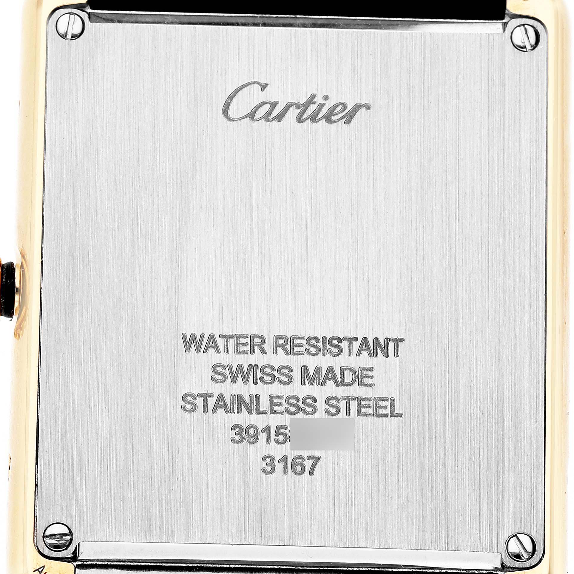 The image shows the back case of a Cartier Tank Solo W5200025 Men's Yellow Gold Silver Dial watch, displaying inscriptions and screws.