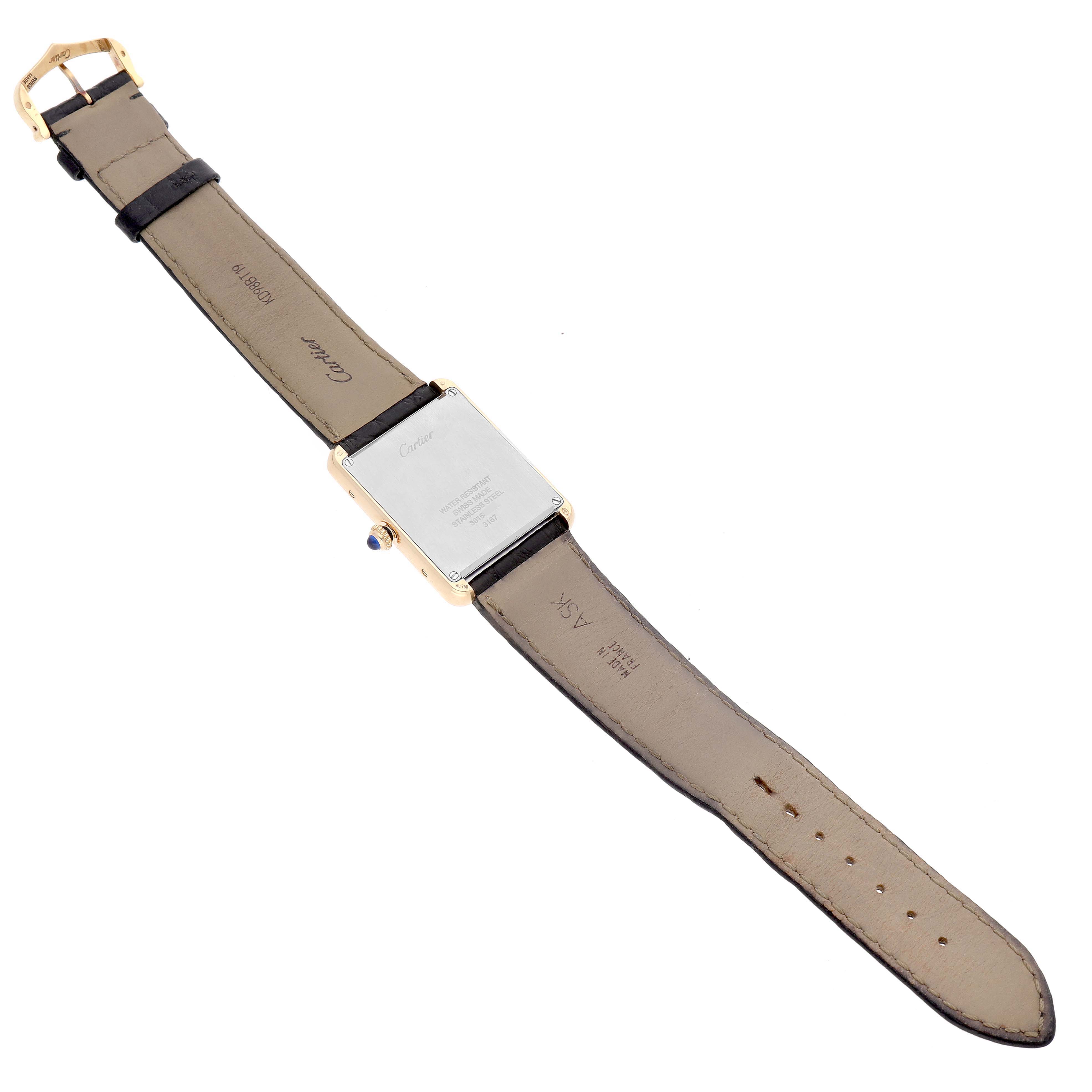 The image shows the back of a Cartier Tank Solo W5200025 Men's Yellow Gold Silver Dial watch with its leather strap laid flat.