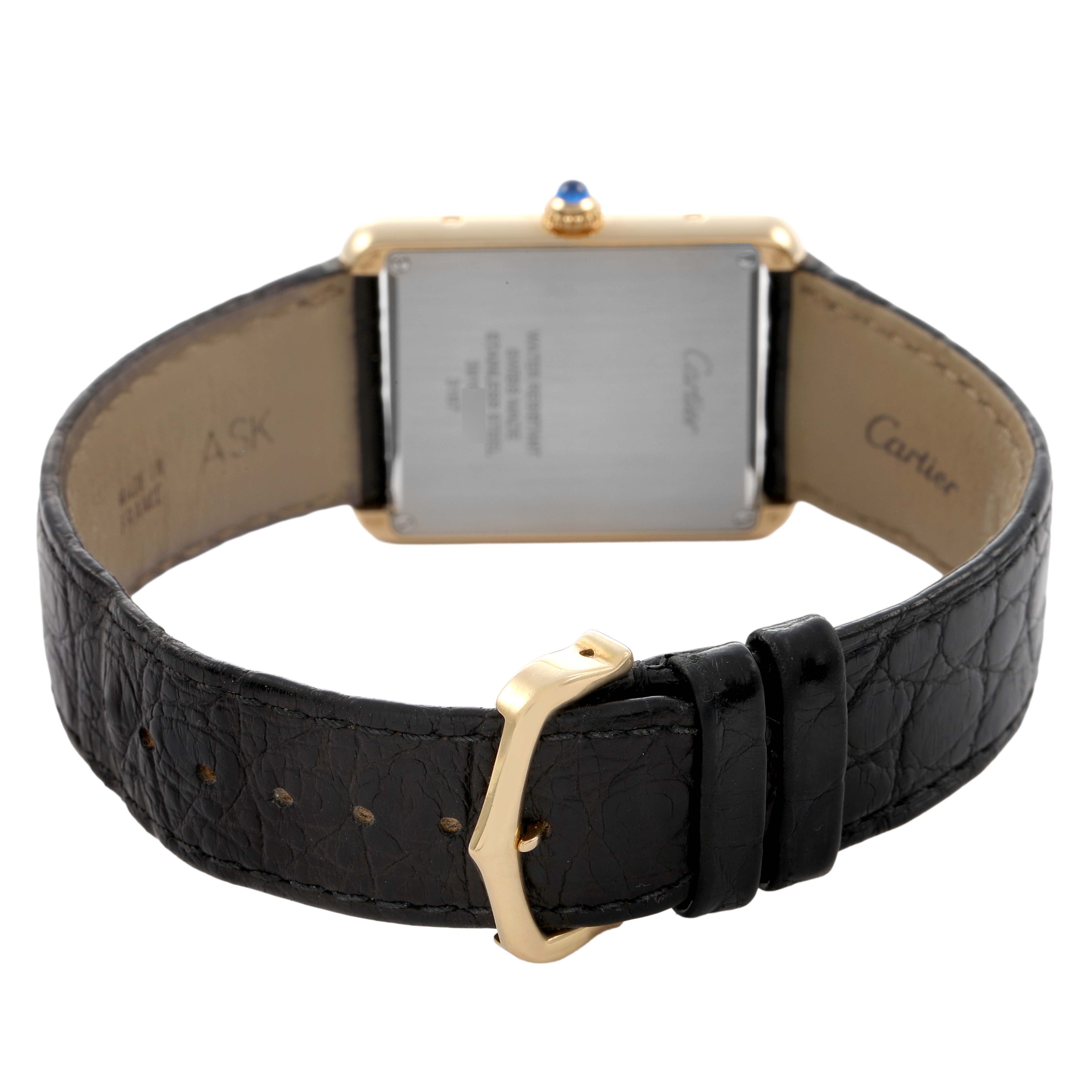 The image shows the back of the Cartier Tank Solo W5200025 Men's Yellow Gold Silver Dial watch, highlighting the clasp and leather strap.