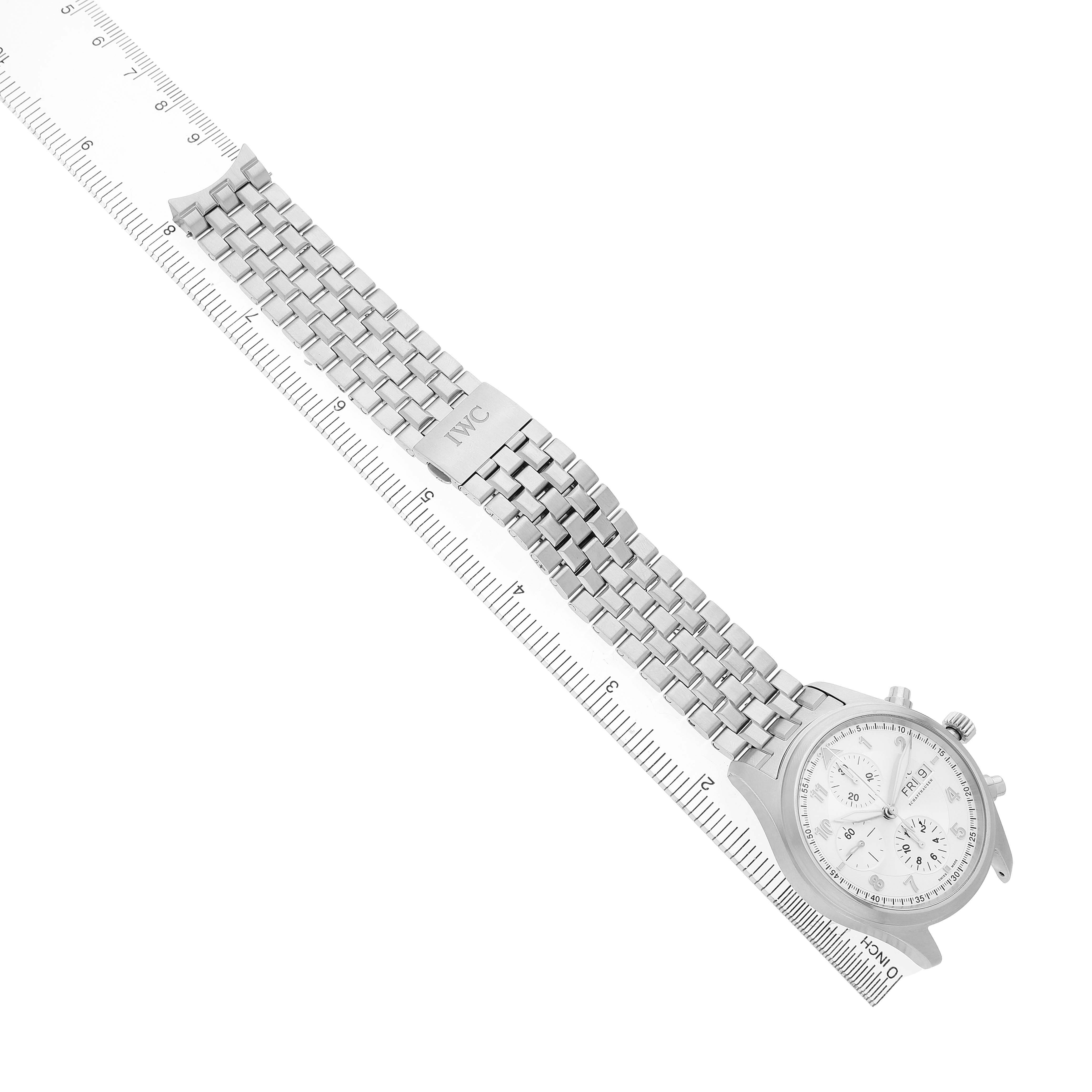 The IWC Pilot IW371705 Men's Stainless Steel Silver Dial model watch is shown from above, displaying the full bracelet, clasp, and face next to a measuring ruler.