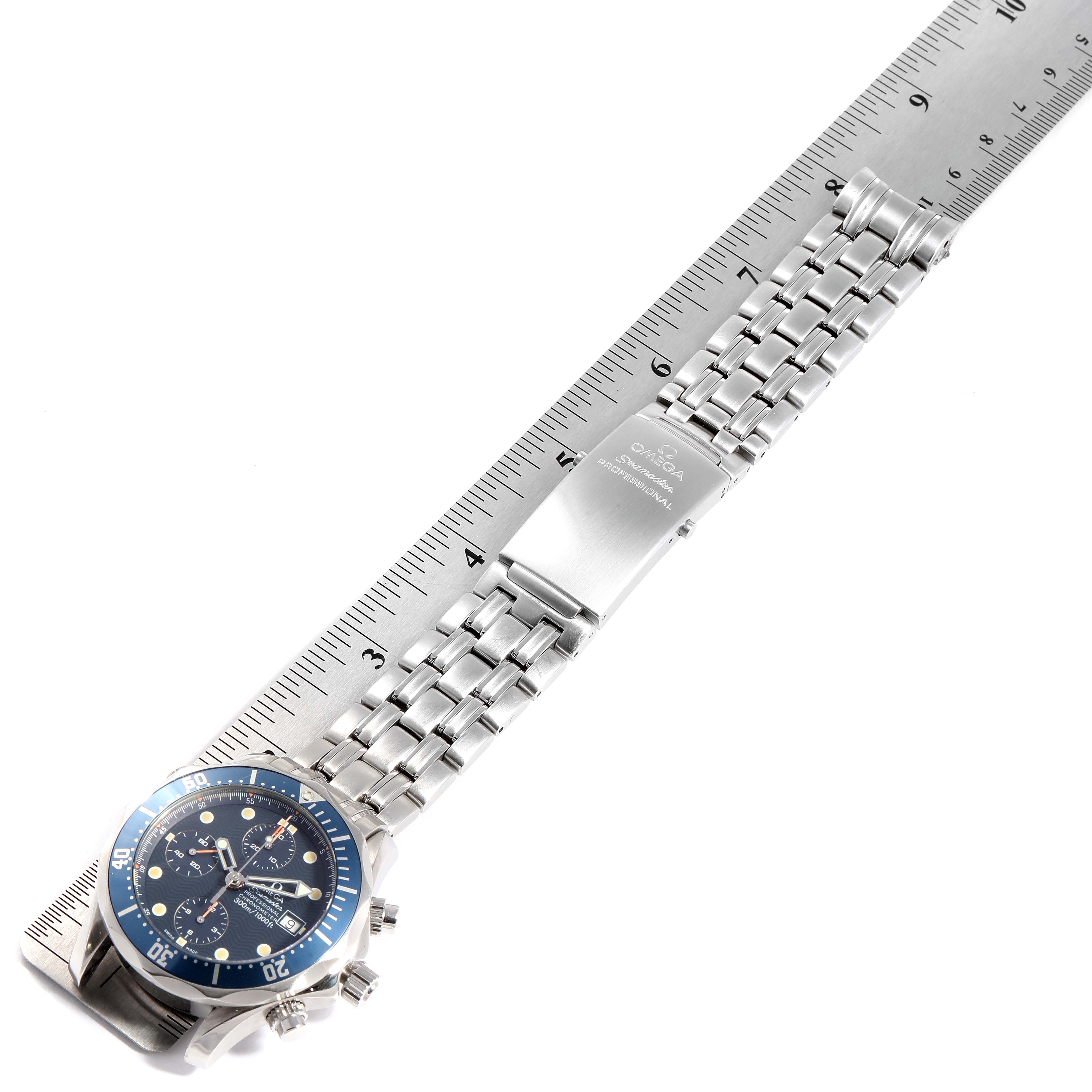 The image shows an Omega Seamaster 2599.80.00 Men
s Stainless Steel Blue Dial 2599.80.00 Men
s Stainless Steel Blue Dial watch laying flat, showcasing its blue bezel, dial, stainless steel bracelet, and clasp, measured with a ruler.