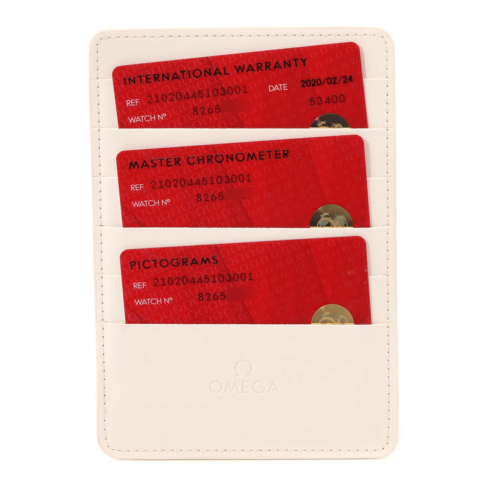 The image shows three red Omega cards for the Seamaster model, including warranty, chronometer certification, and pictograms in a white holder.