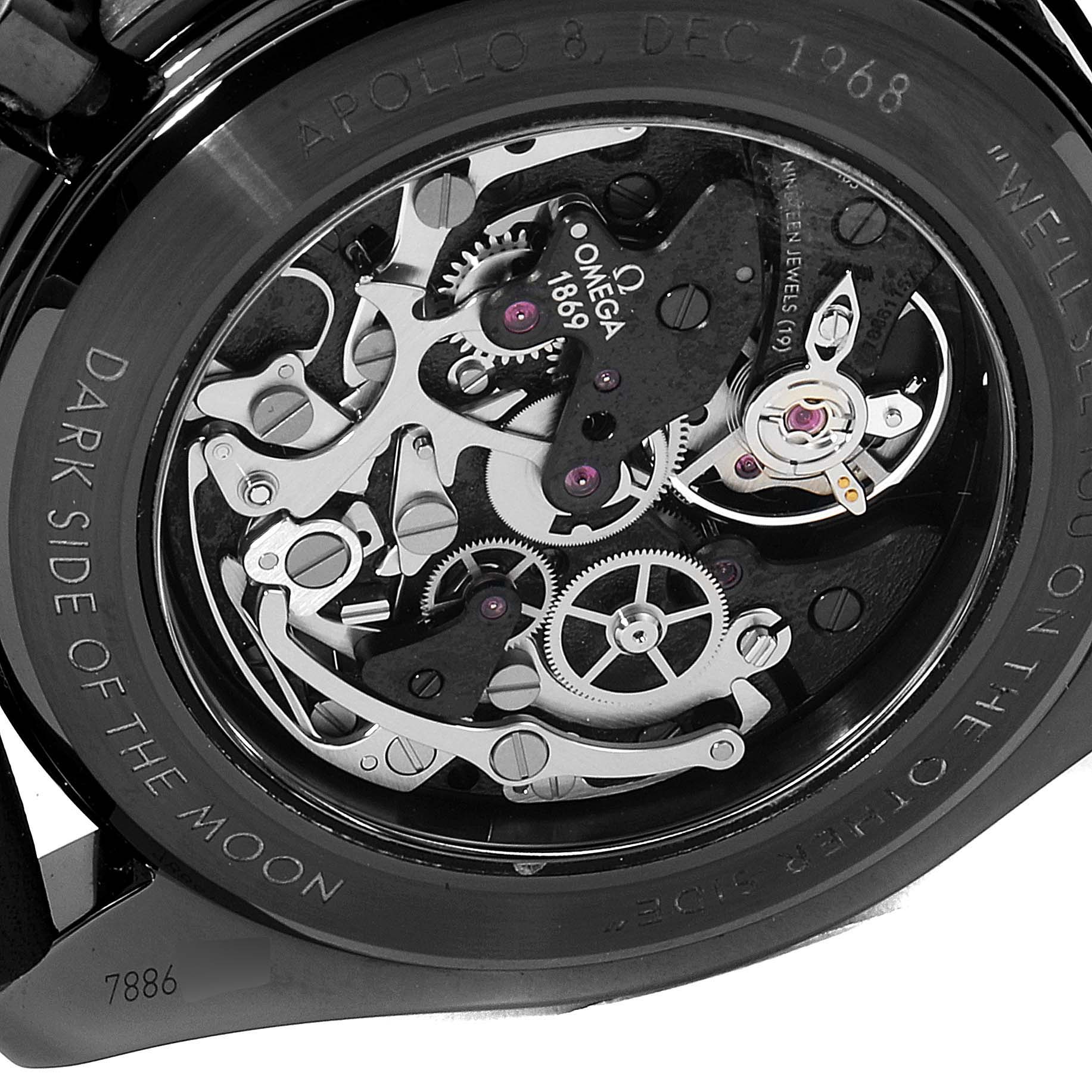 The image shows the back view of an Omega Speedmaster 311.92.44.30.01.001 Men's Titanium Black Dial 311.92.44.30.01.001 Men's Titanium Black Dial watch, revealing its intricate mechanical movement and parts.