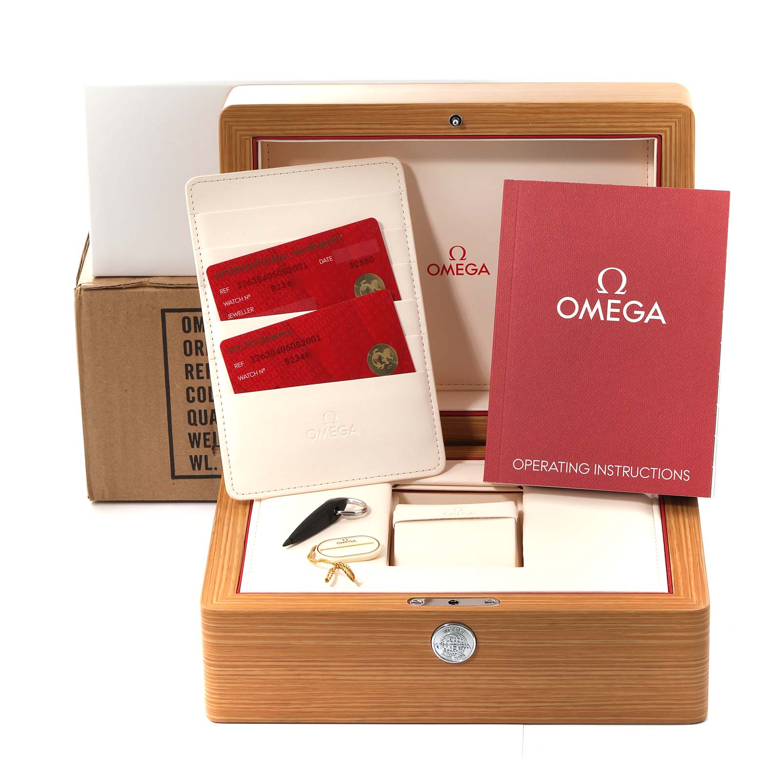 The image shows an Omega Speedmaster 326.30.40.50.02.001 Men
s Stainless Steel Silver Dial 326.30.40.50.02.001 Men
s Stainless Steel Silver Dial watch box, operating instructions, warranty cards, and accessories, all from a front angle.