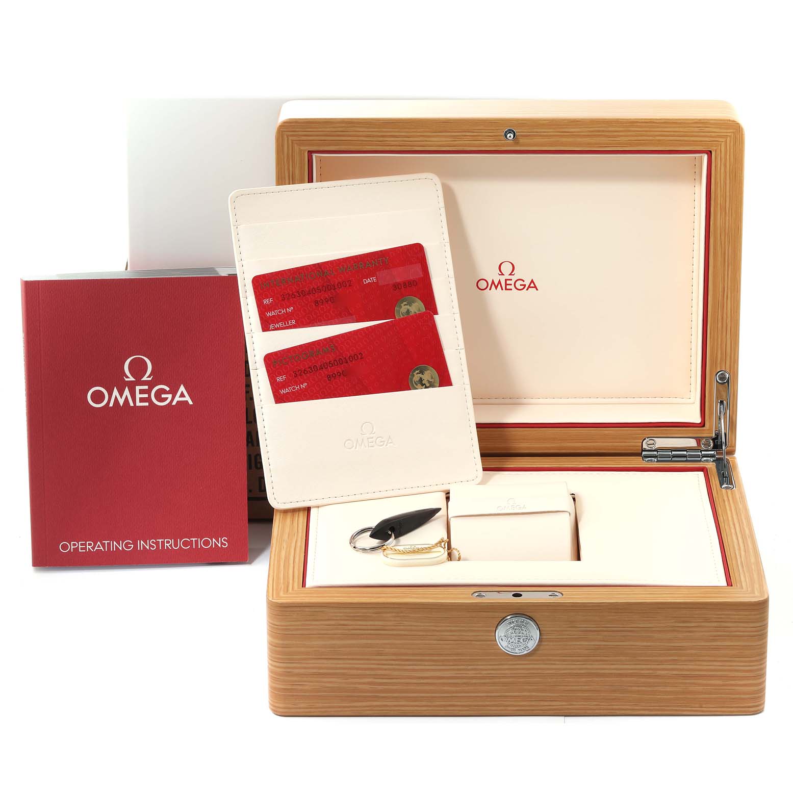 This image shows the accessories for the Omega Speedmaster 326.30.40.50.01.002 Men
s Stainless Steel Black Dial 326.30.40.50.01.002 Men
s Stainless Steel Black Dial, including the watch box, operating instructions, cards, and keychain.