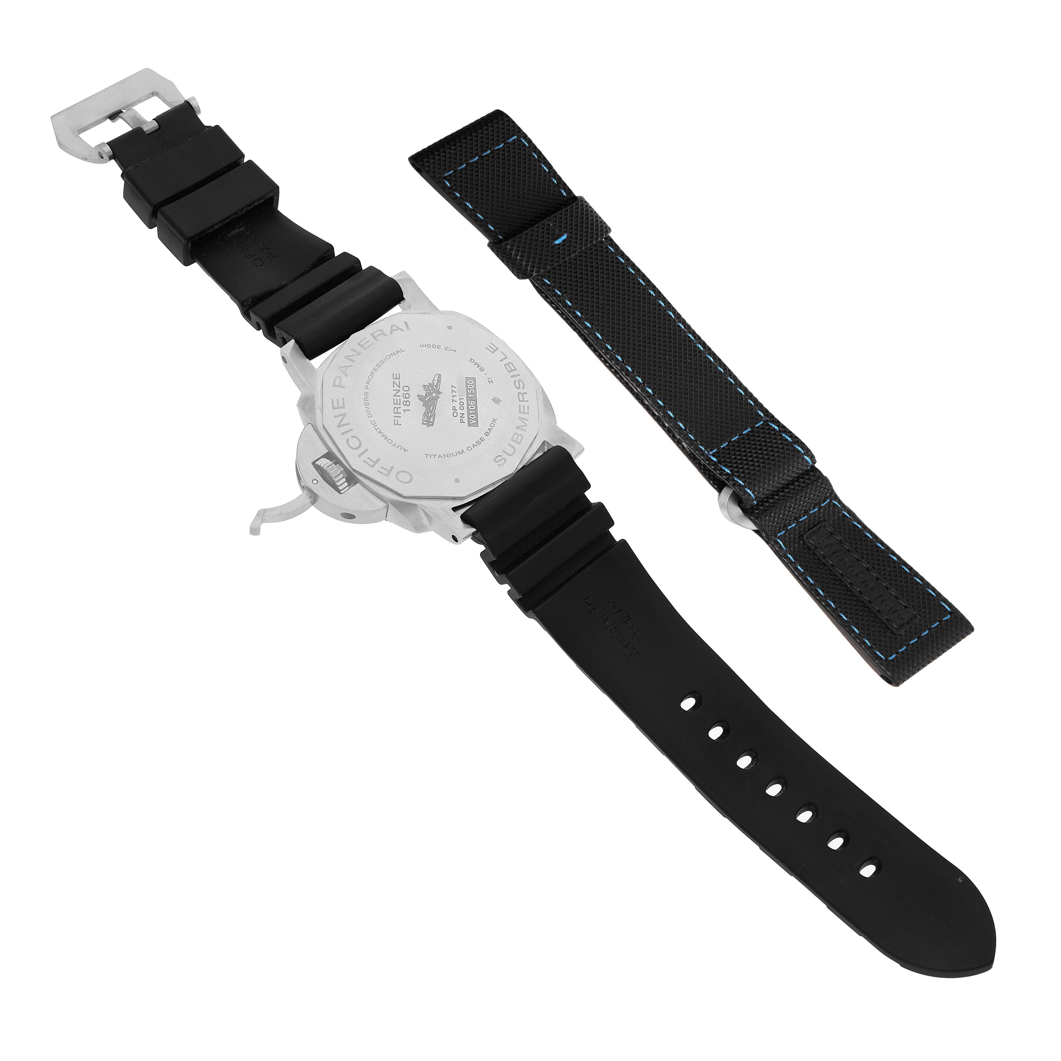 The image shows the back of a Panerai Luminor PAM00799 Men's Titanium Black Dial watch with a rubber strap and an additional blue-stitched fabric strap.