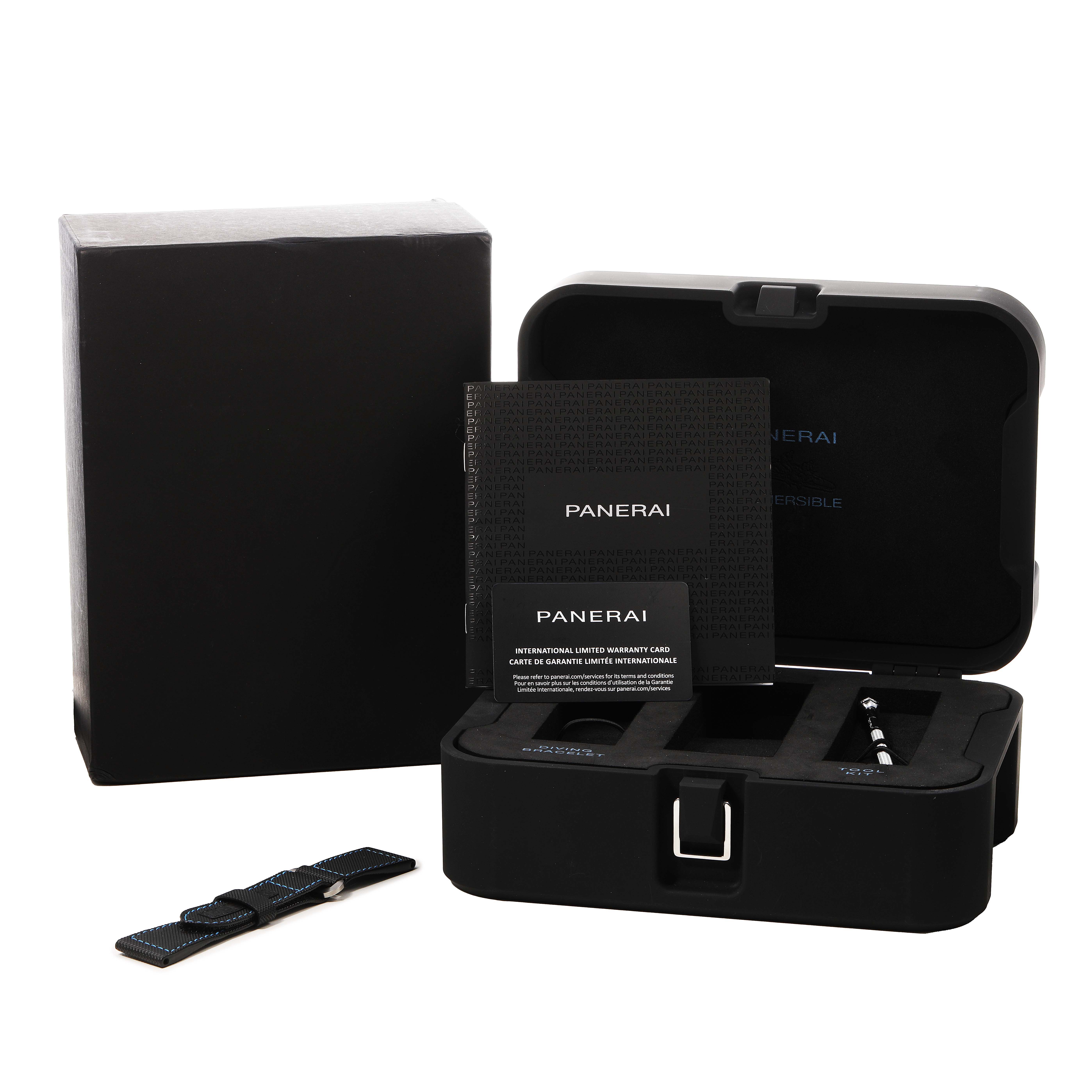 The image shows a Panerai Luminor PAM00799 Men's Titanium Black Dial case, an additional strap, warranty cards, and a tool, all from a front angle.