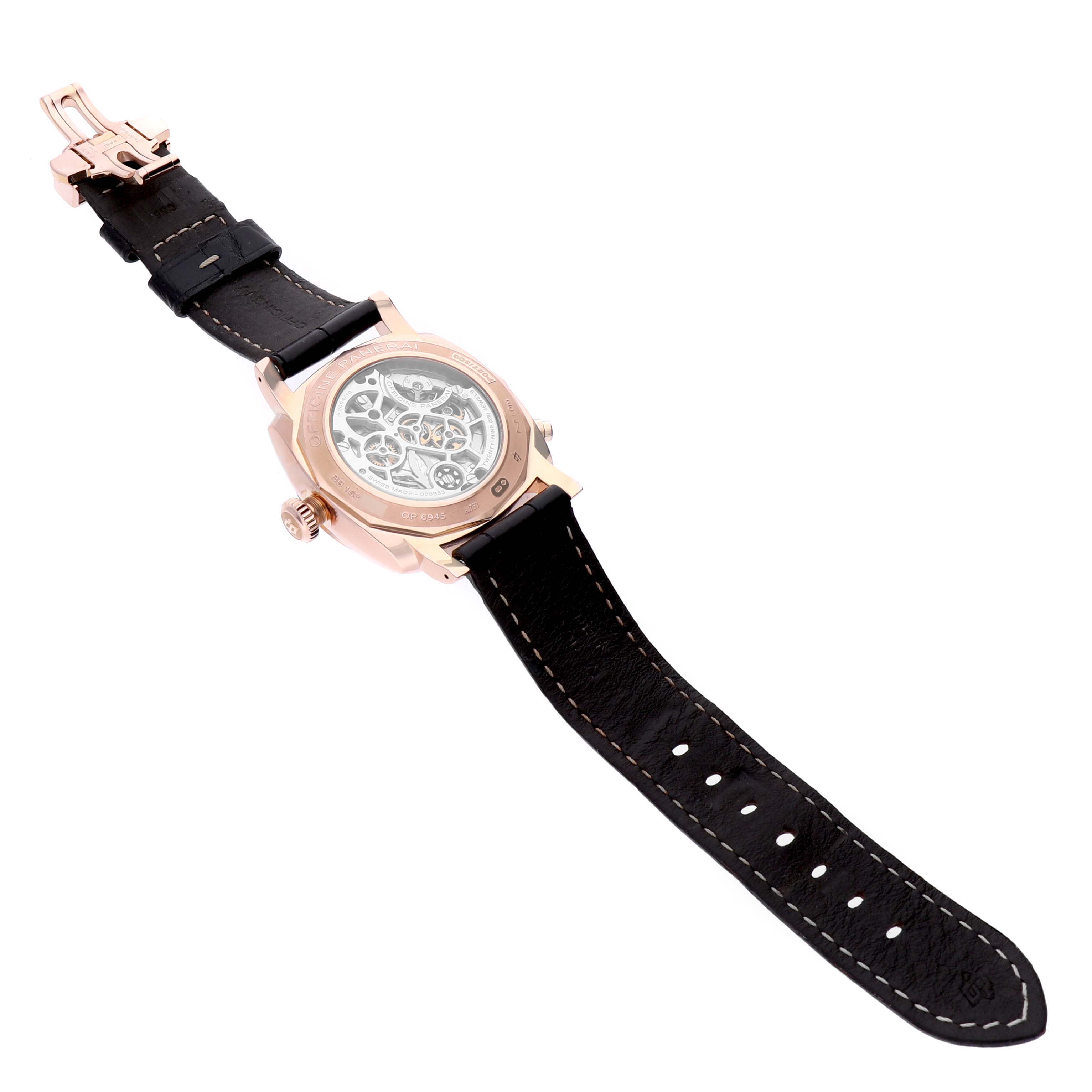 The Panerai Radiomir PAM00502 Men's Rose Gold Brown Dial PAM00502 Men's Rose Gold Brown Dial watch is shown from the back, highlighting its transparent case back and intricate movement, along with a leather strap and buckle.